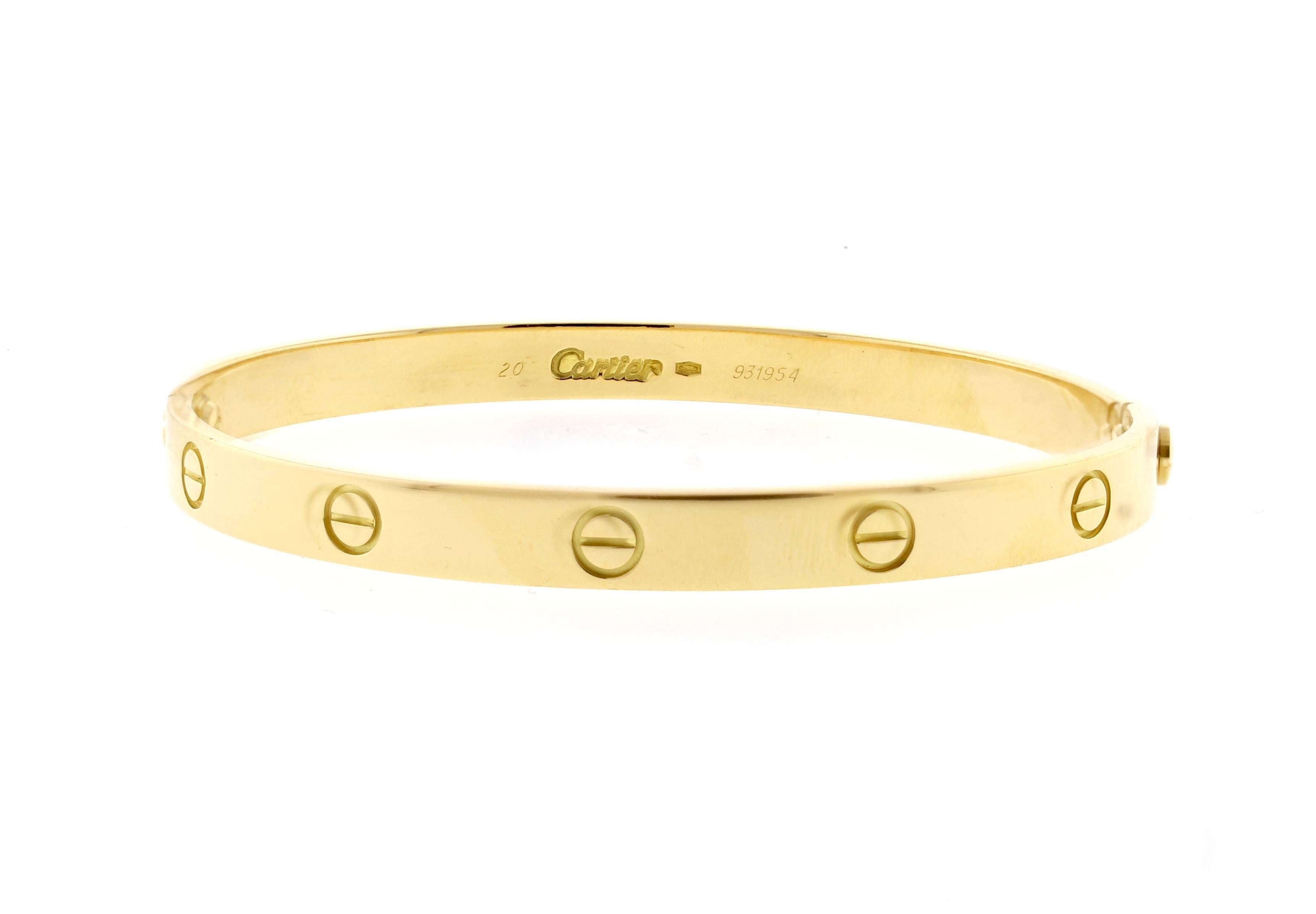 18 karat yellow gold Cartier Love bracelet. The love bracelet remains an iconic symbol of love that transcends convention. Original design, type 1, Size 20,  screwdriver, Cartier box.  
Certificate of Authenticity, sales receipt, Polished to like