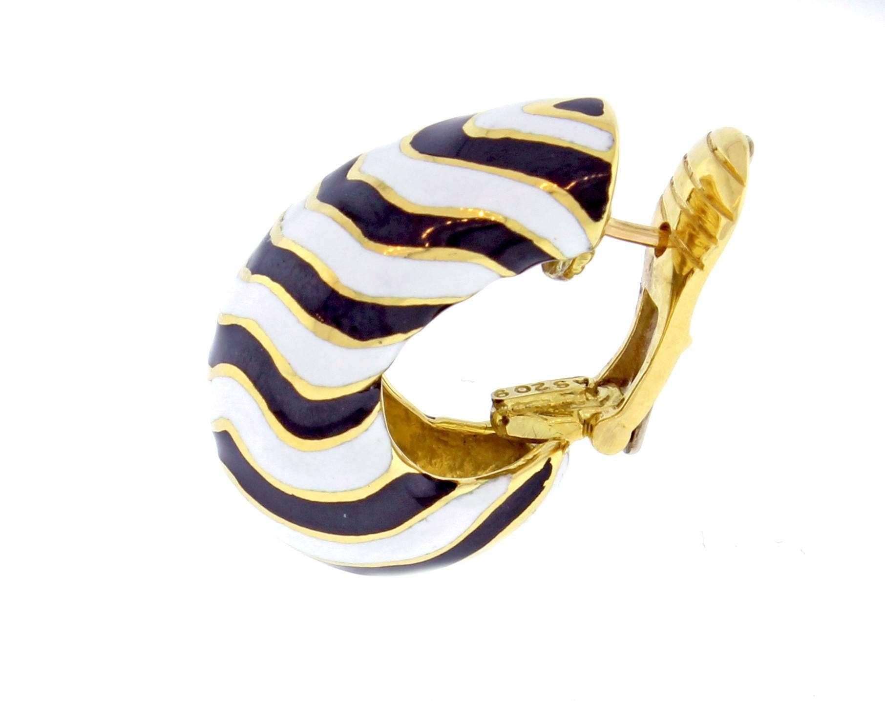 From acclaimed jeweler David Webb,s kingdom collection, a pair of stunning zebra hoop earrings. The white and black enamel earrings are meticulously crafted in 18 karat gold. Measuring 1 inch high and ½ inch wide.