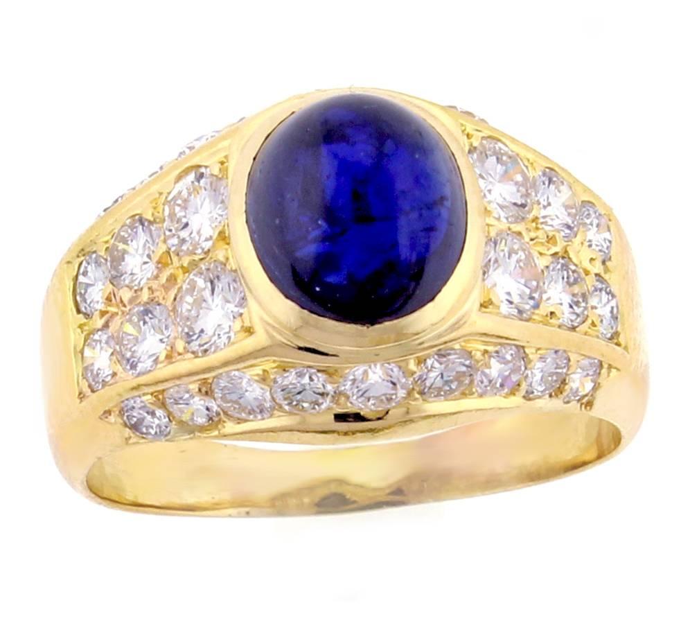 From Van Cleef & Arpels, a cabochon sapphire and diamond 18 karat gold ring. The ring features  an approximately 2.50 cart rich blue cabochon sapphire measuring 6.75*7.5mm. There are an additional 30 brilliant cut diamonds weighing approximately