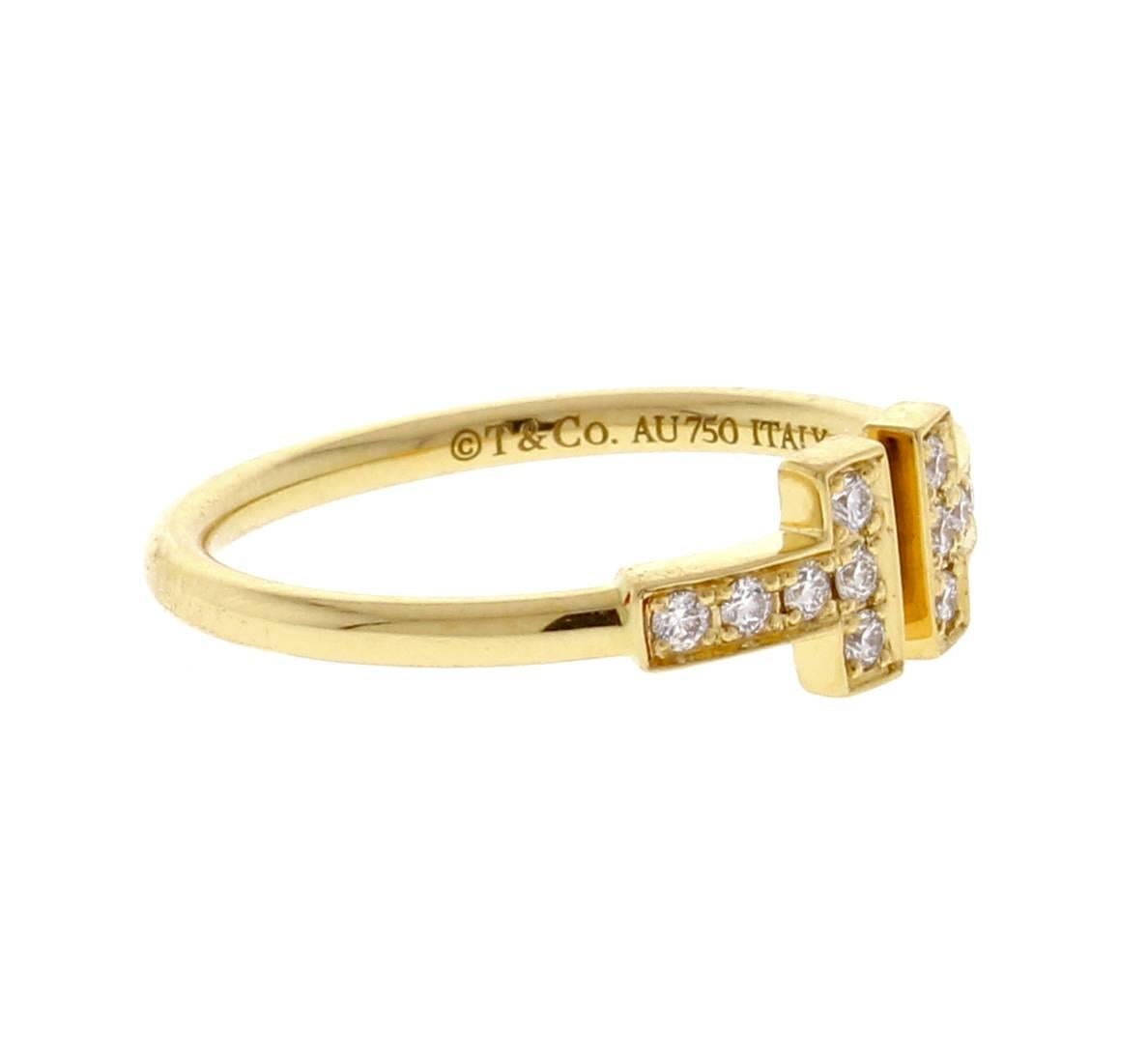 Graphic angles and clean lines blend to create the beautiful clarity of the Tiffany T collection. Dazzling diamonds accentuate this ring's bold and timeless form. 12 Brilliant diamonds weigh .13 carats. crafted in 18 karat gold. Size 6