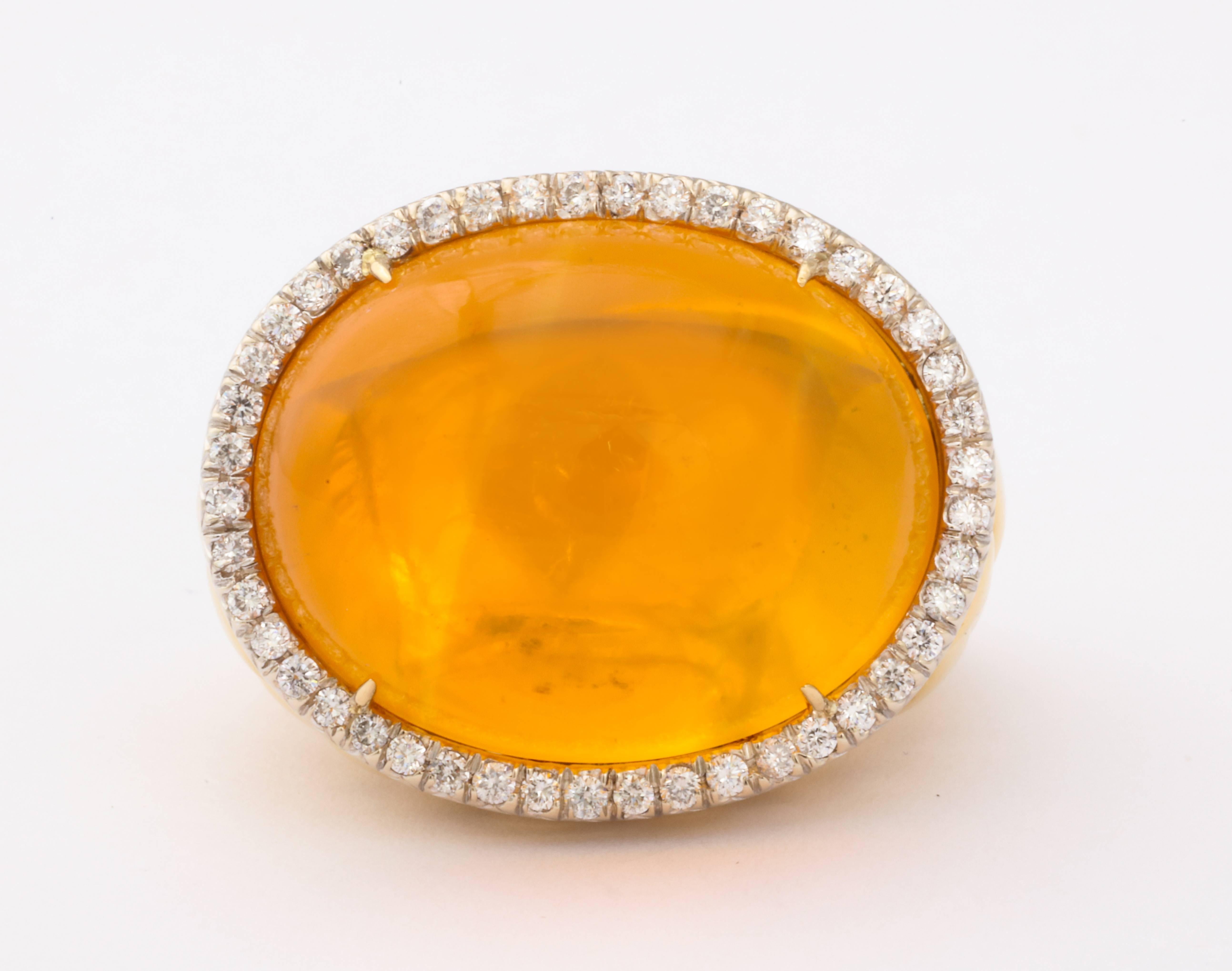 18kt yellow gold fire opal and white diamonds ring.
Current size 9, but can be sized down for customer. 