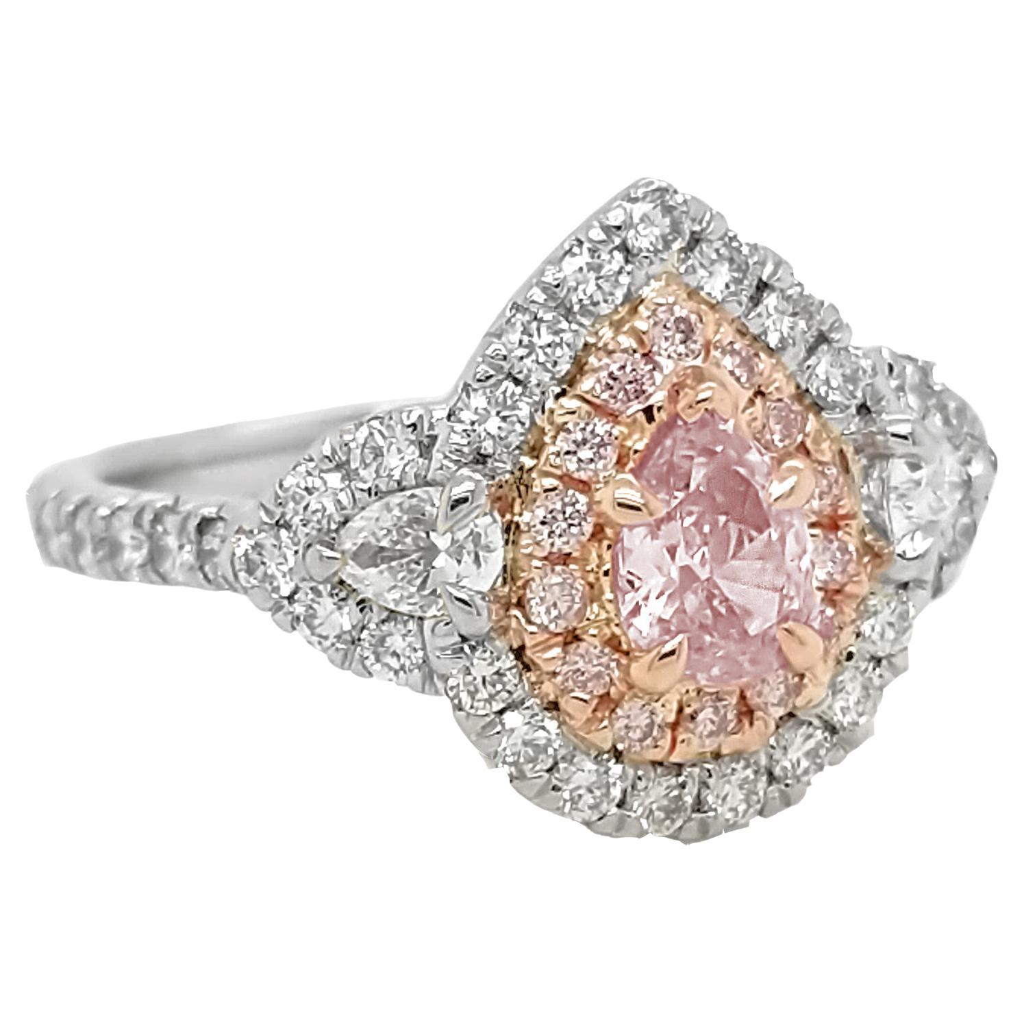 Make a statement with this stunning ring set with a 0.43 carat fancy pink diamond with GIA#:5191982650. The ring also features 0.18 carats of pink melee, 2 pear shapes weighing .60 carats, F/VS, and .87 carats of white melee, adding even more