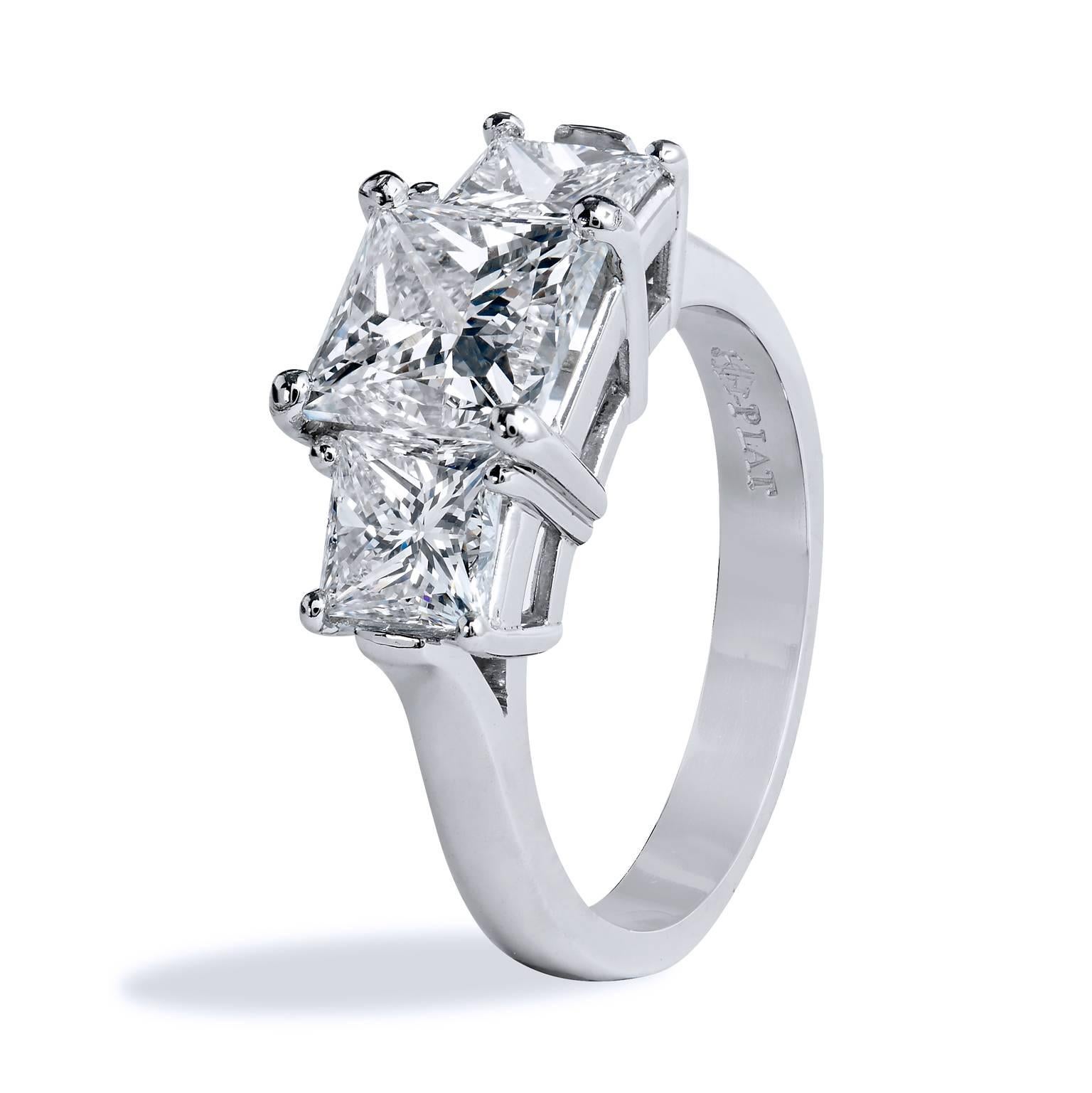 Crafted in platinum, this ring features three impressive GIA certified diamonds symbolizing past, present and future.  Taking center stage as the focal point of this stunning engagement ring is a 2.02 GIA certified diamond graded H VS2. Flanking the