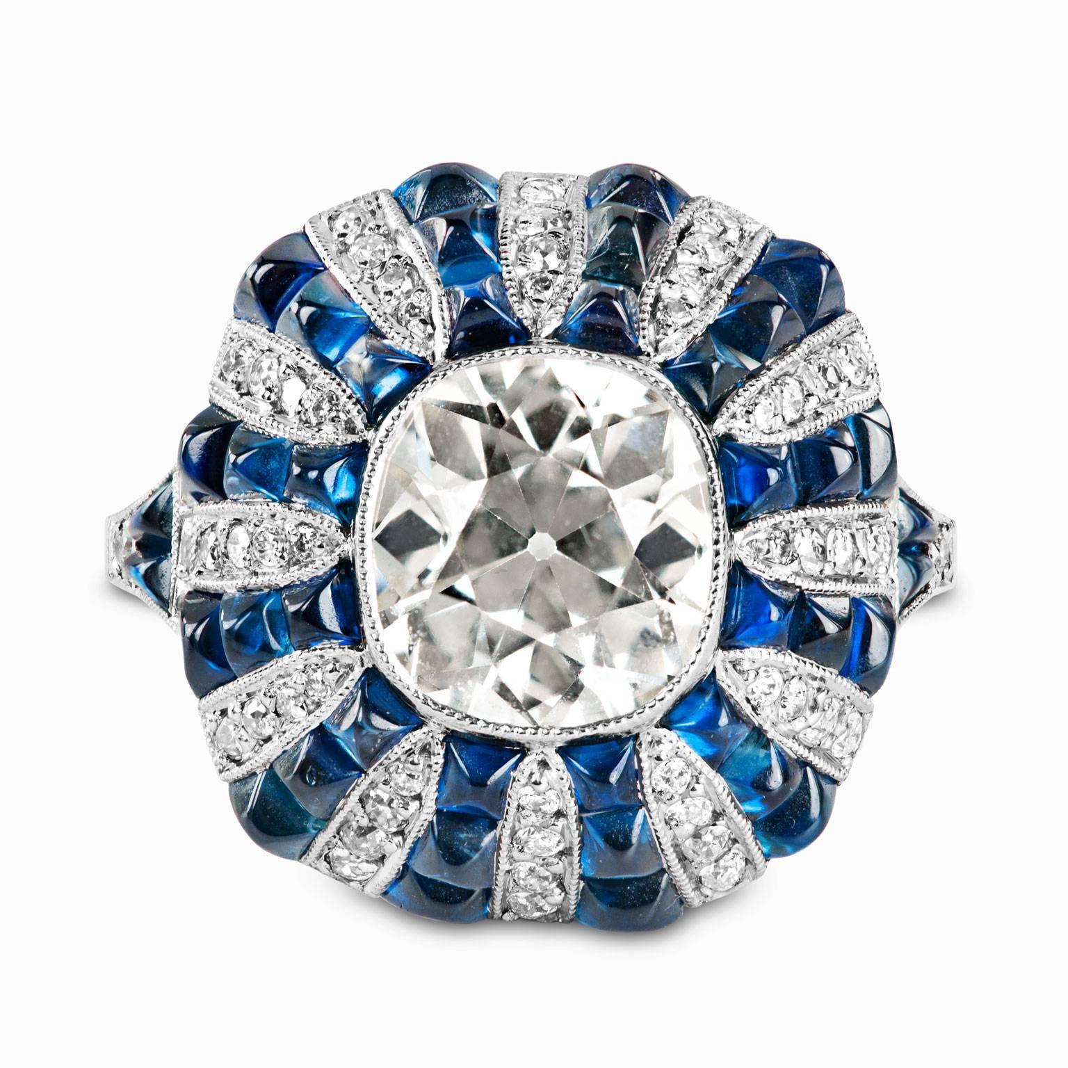 GIA Certified 2.63 Carat Center Diamond with an additional 56 diamonds totaling another .50 Carats. 
The Sapphires are Sugar Loaf Cut.  There are 40 individual stones with the approximate weight of 4 total carats.  

This is a new ring that has an