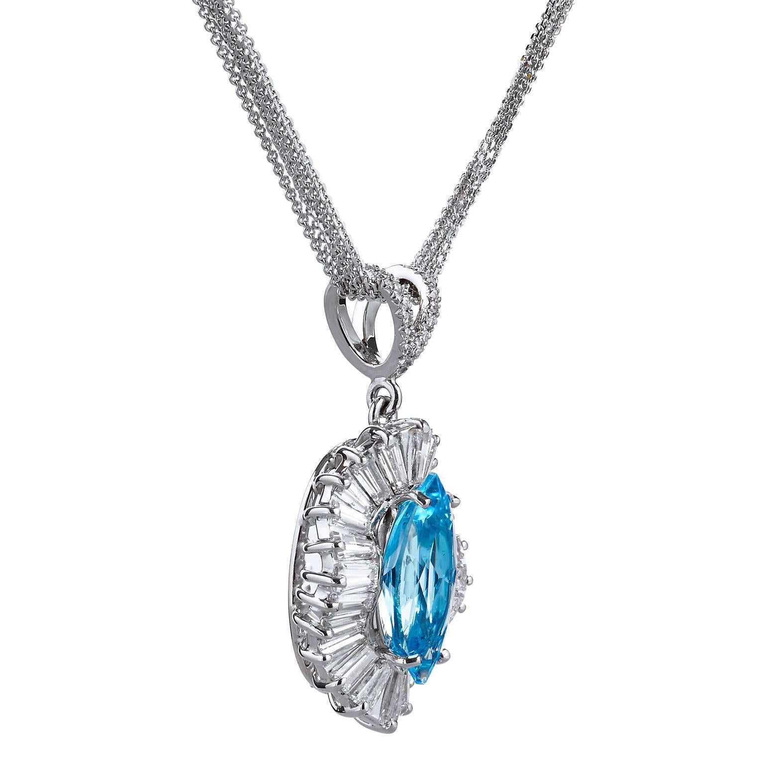 Ballerina style pendant in fourteen karat white gold, featuring a 15mm x 7mm marquise shaped blue topaz weighing approximately 3.65 carats set with four prongs, the vivid center stone is highlighted by approximately 2.50 carats of tapered baguette