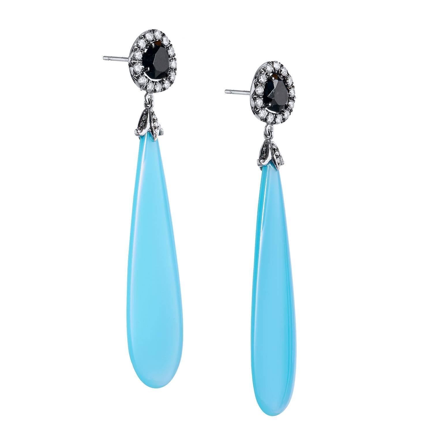 Luscious earrings hand crafted and designed by H earrings in eighteen karat white gold, Fashionably sized at 2 1/2 inches long, featuring tongue cut Laguna Blue Agate Drops, attached to a button top of Black Spinel, surrounded by white round