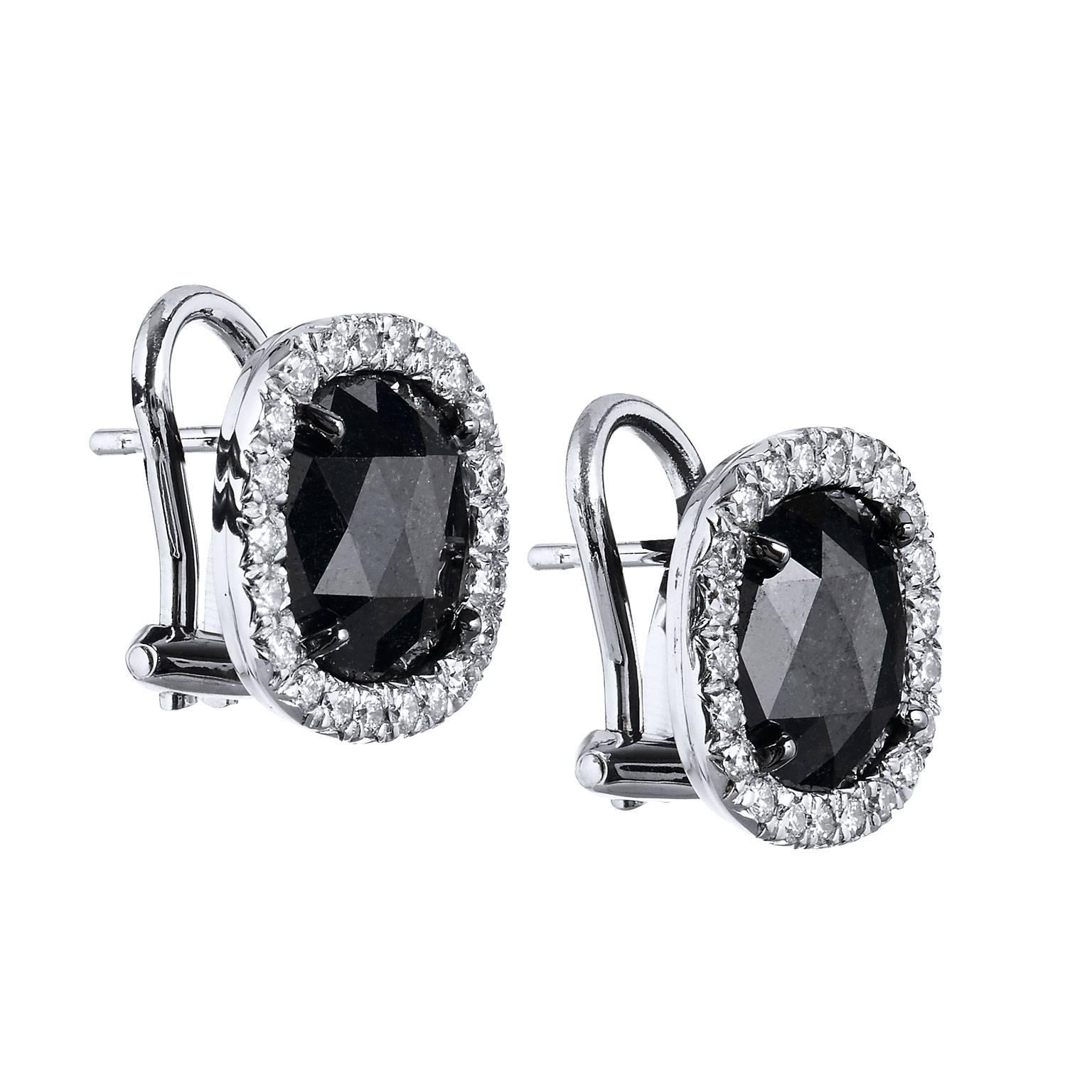 Opulence from the H&H Diamond Slice Collection, designed & hand made by H&H, in Eighteen Karat White Gold, with 5.10 carats of cushion shaped  faceted black diamonds, surrounded by forty four round brilliant cut diamonds with a total weight of .49