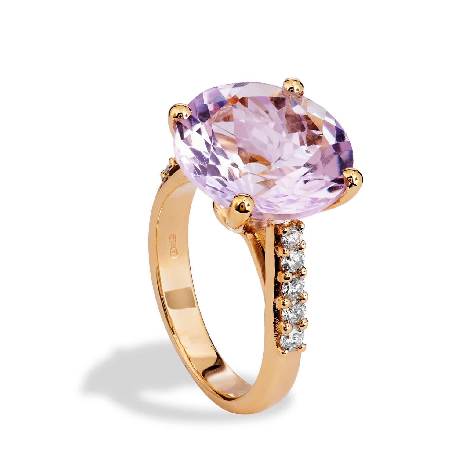  Beautiful Eighteen Rose Gold Ring highlighting a significant Fourteen Millimeter Pink Amethyst prong set weighting ten (10) Carats. Down the sides the Ring has ten round brilliant cut diamonds, set with shared prongs, weighting .38 carats G in