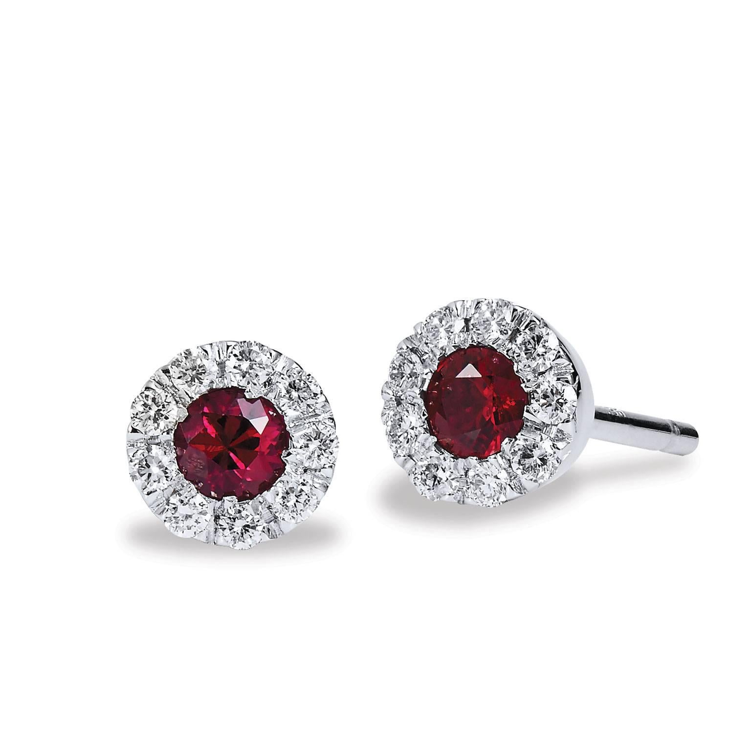 Delicate Ruby and Diamond Earrings , crafted in Eighteen Karat White Gold with two round, three millimeter rubies which
are encircled by nine round brilliant cut diamonds (18 total)
The Rubies are .25 carats total weight and the diamonds weight