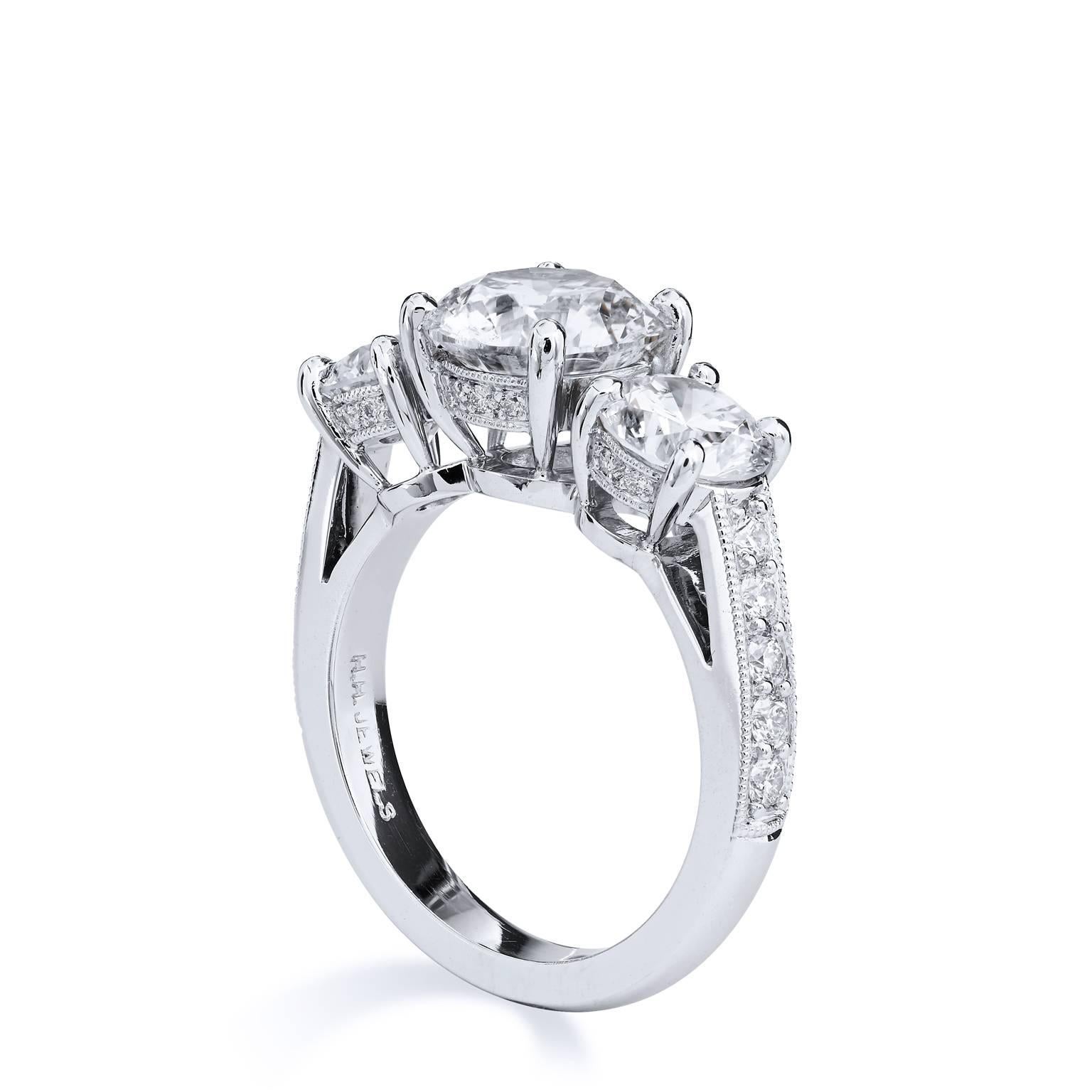 Embody the radiance of an angel in this diamond and platinum ring. A 2.34 ct GIA certified diamond (J/ SI2- GIA# 5121502339) sits at center while two shimmering 1.80 ct diamonds (K/SI1/SI2) adjoin at both sides of the center diamond as 14 pieces of