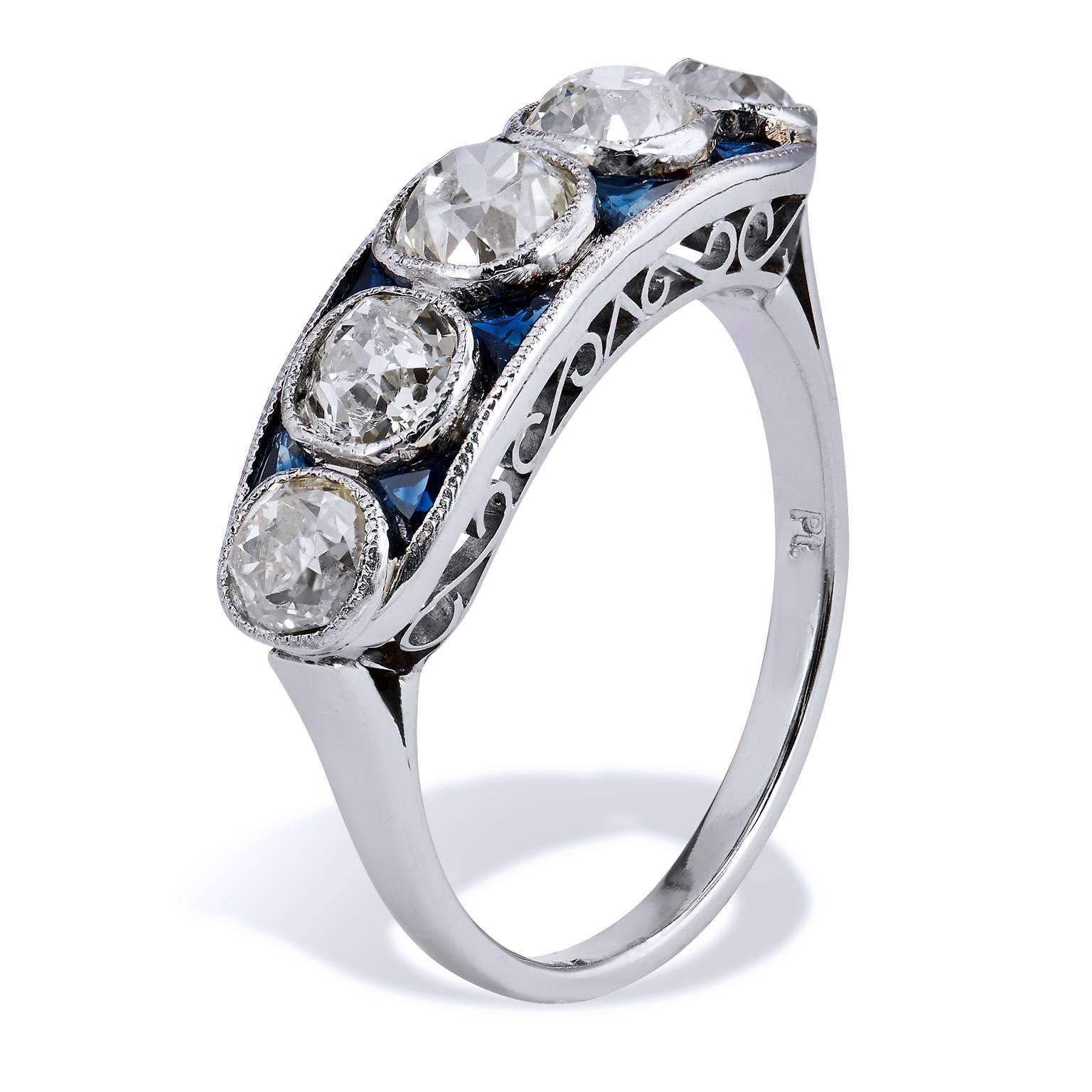 Art Deco Inspired 2.40 Carat Old Mine Cut Diamond Sapphire Platinum Band Ring

This Art Deco inspired platinum diamond band ring features five pieces of old mine cut diamonds, bezel set, with a total weight of 2.40 carats. Interlaced between the sea
