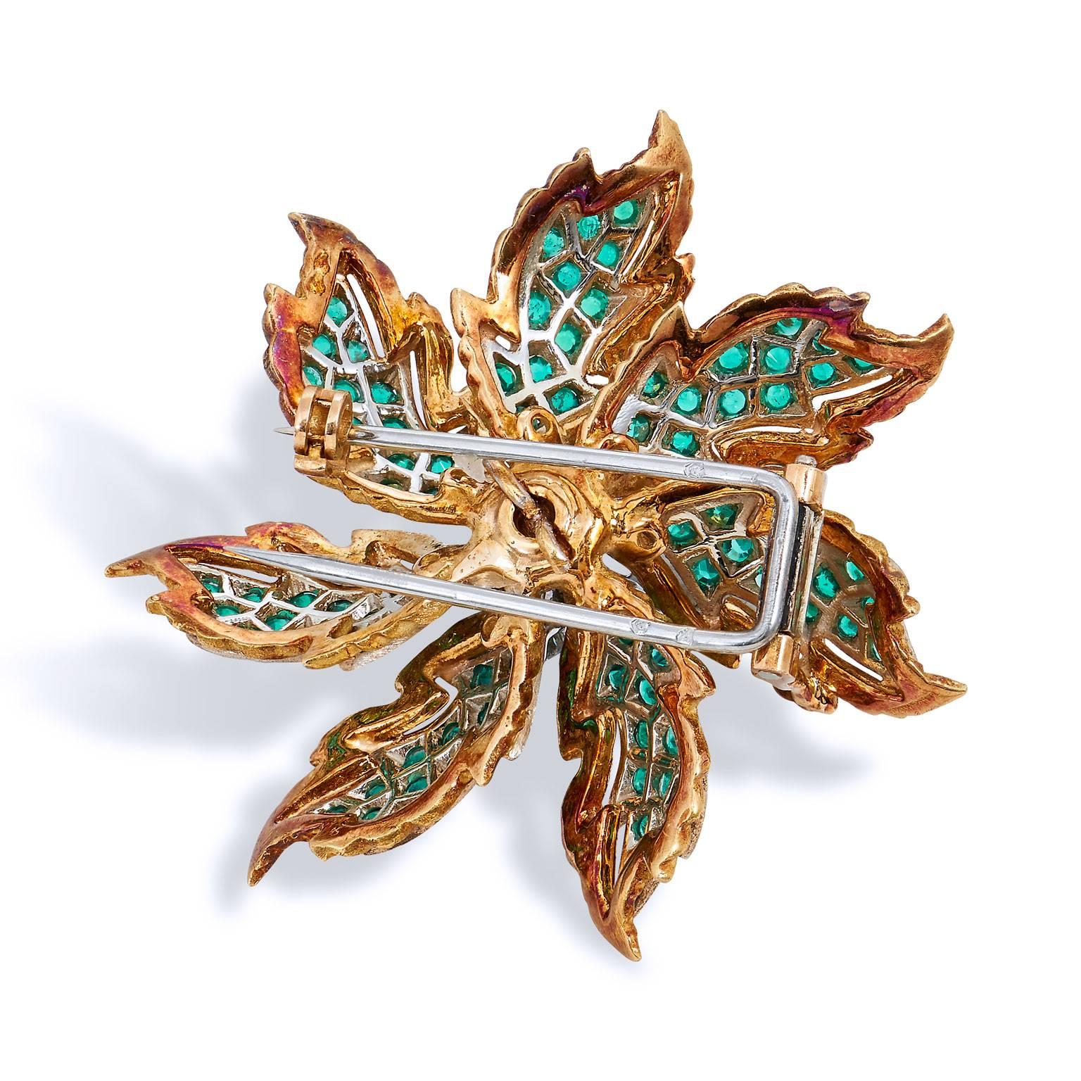 Enjoy this previously loved 18 karat white and yellow gold, emerald and diamond brooch. This exquisite French made brooch features eighty-four pieces of emerald, resulting in a total weight of 1.50 carat, and 0.75 carat of diamond in color H and