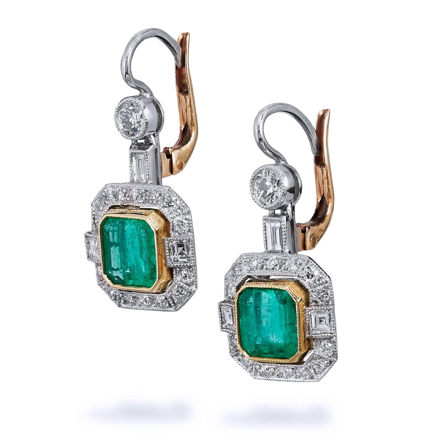 Antique inspired platinum and 18 karat yellow gold drop earrings featuring two Colombian emeralds set at center with a total weight of 2.30cts. For further enhancement, a total weight of 1.20 carat of Old European cut, Carre cut and straight