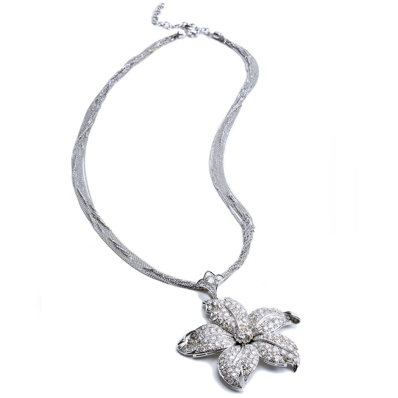 Flowers are nature’s symbol of life and compassion with the uncanny power to evoke happiness. This eternal 1940’s flower pendant is exquisitely handmade and fruitfully boasts approximately 12.85 carats of glistening diamonds set in platinum with