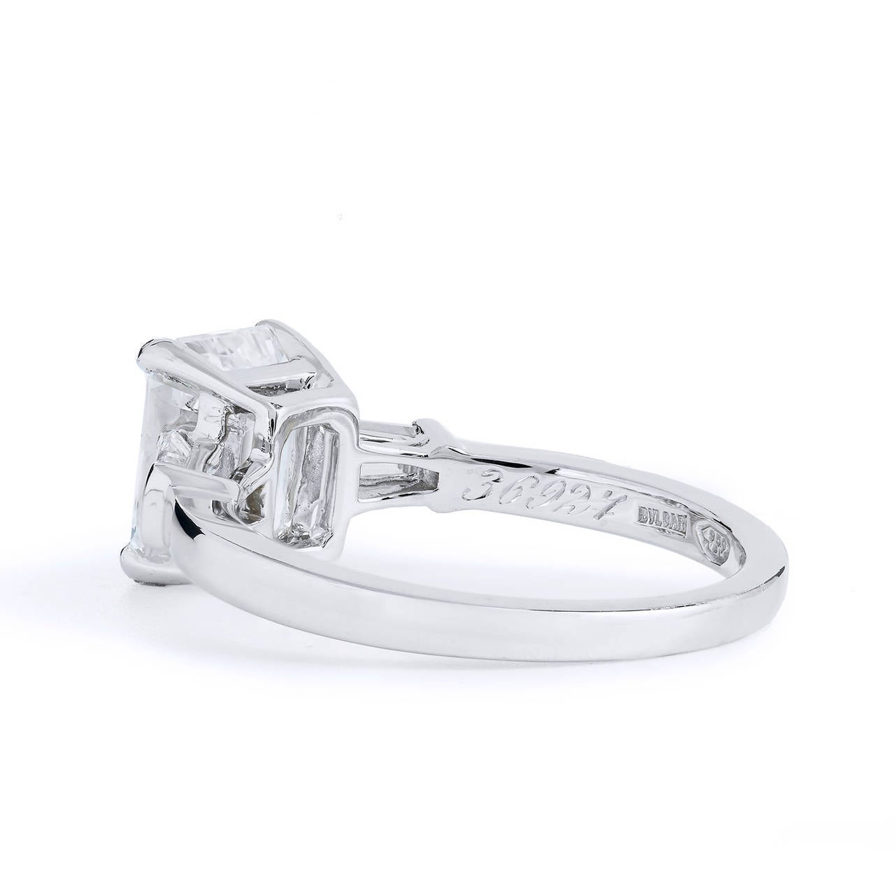 Bvlgari immortalizes beauty once again with this platinum GIA certified diamond ring. Capturing the true essence of elegance and femininity, this stunning ring showcases a 2.01 E-SI1 emerald cut diamond embraced by two tapered baguettes weighing