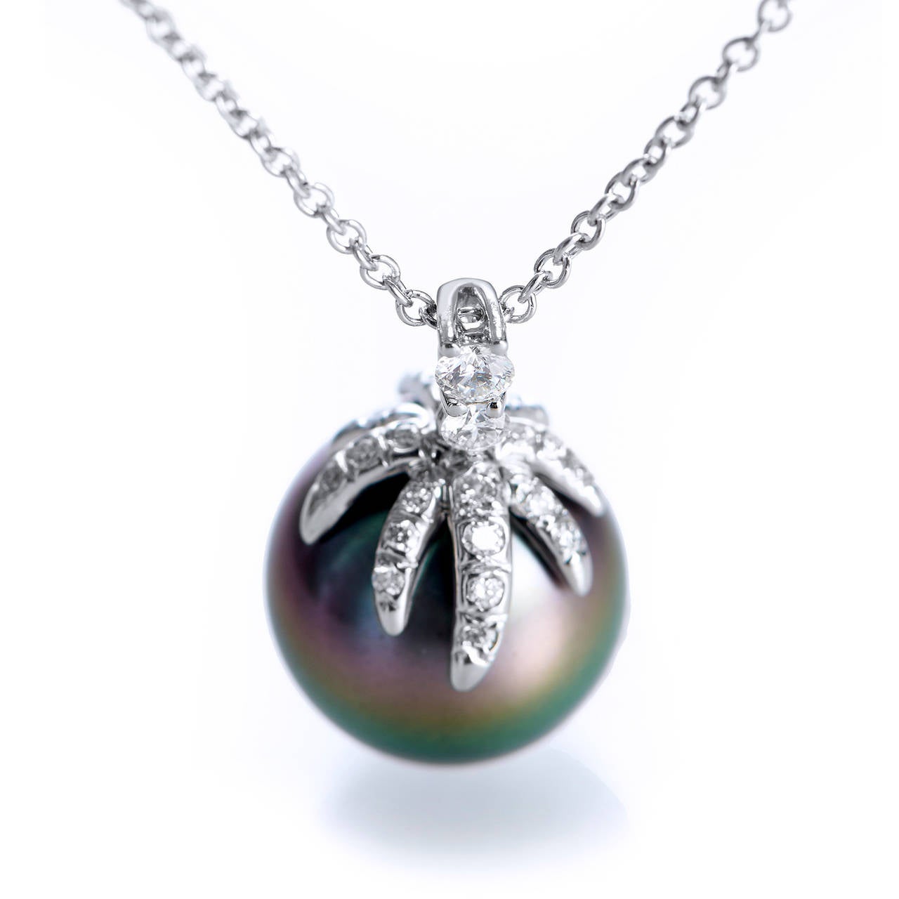 A part of Tiffany & Co.’s retired “Fireworks” collection, this drop necklace is a rare find. The piece features a seductive Tahitian Cultured Pearl measuring approximately 11mm grasped by a platinum claw of approximately .14 cts pave set diamonds