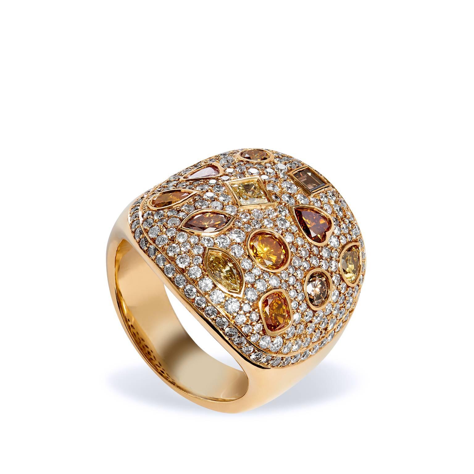 This bold 18kt yellow gold cocktail ring exudes pure glamour. The oval shape ring features a variety of natural colored diamonds totaling 1.96cts set on a twinkling canvas of 1.68ct pave diamonds graded F-VS. 