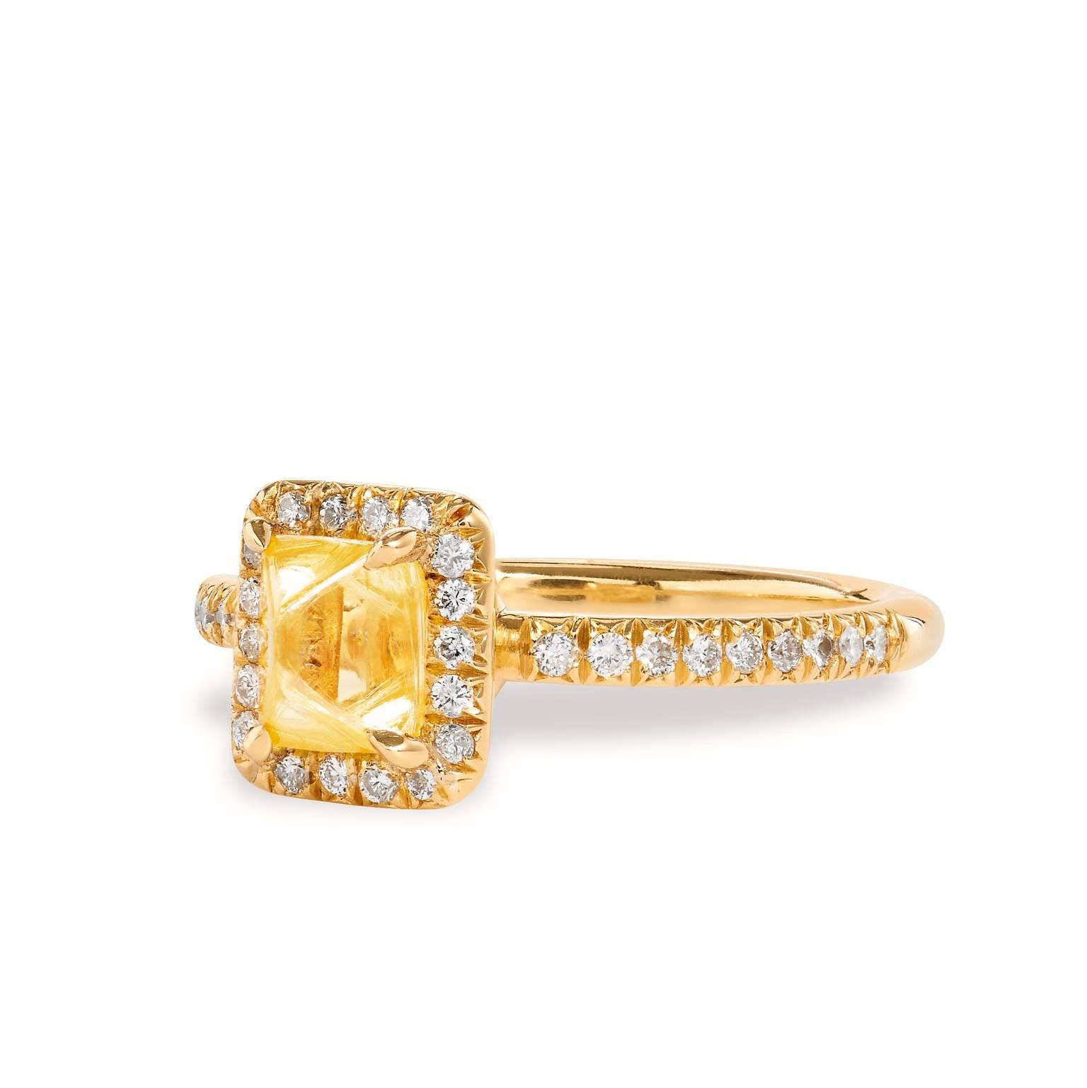 This handmade 18 karat yellow gold ring showcases a 1.20 carat fancy yellow rough diamond highlighted by 0.26 carat of pave diamond that encircle center diamond and trail down the shank (G/H SI).
