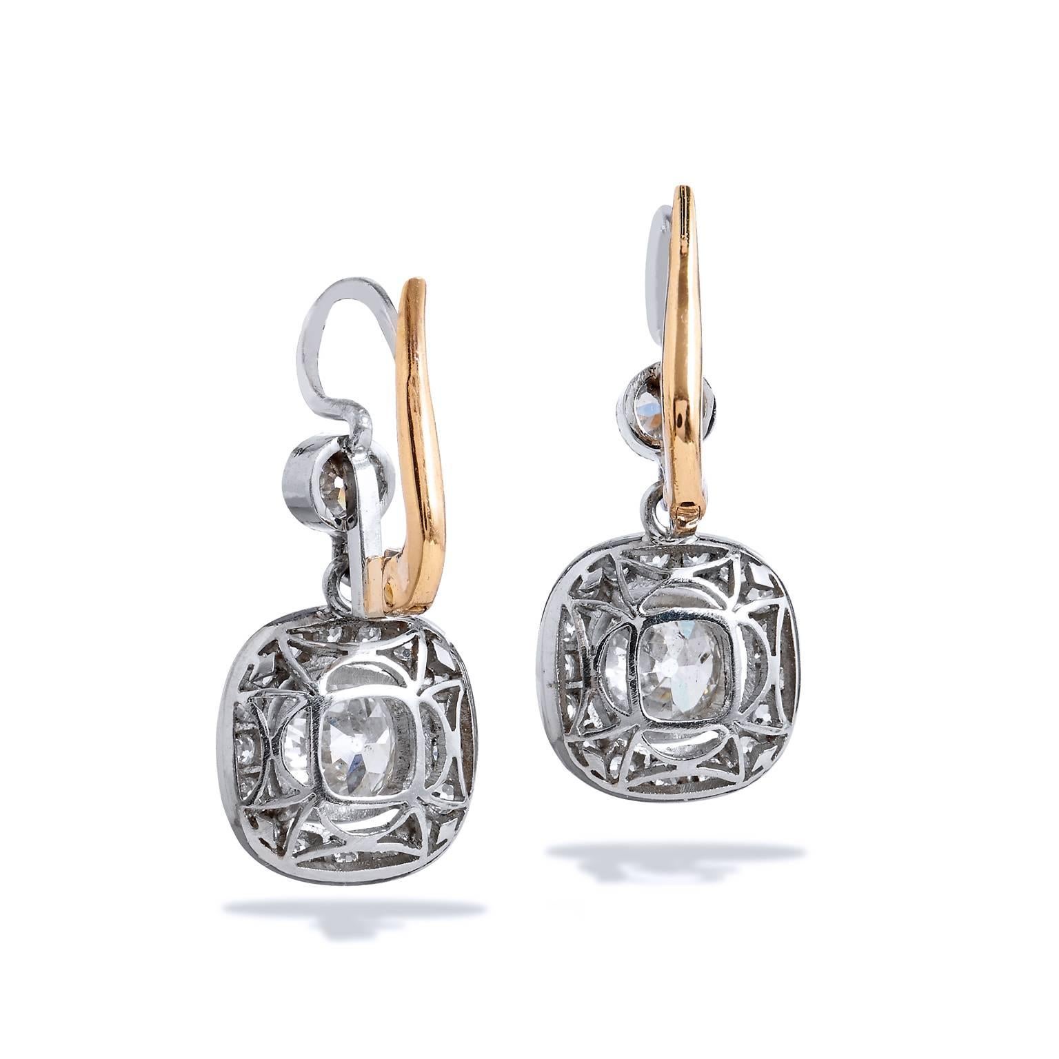 This set of Art Deco style earrings are handcrafted in platinum and feature a unique design touch with 18kt yellow gold on the backside. The pair hosts a total of 1.96ct old mind cushion cut diamonds.