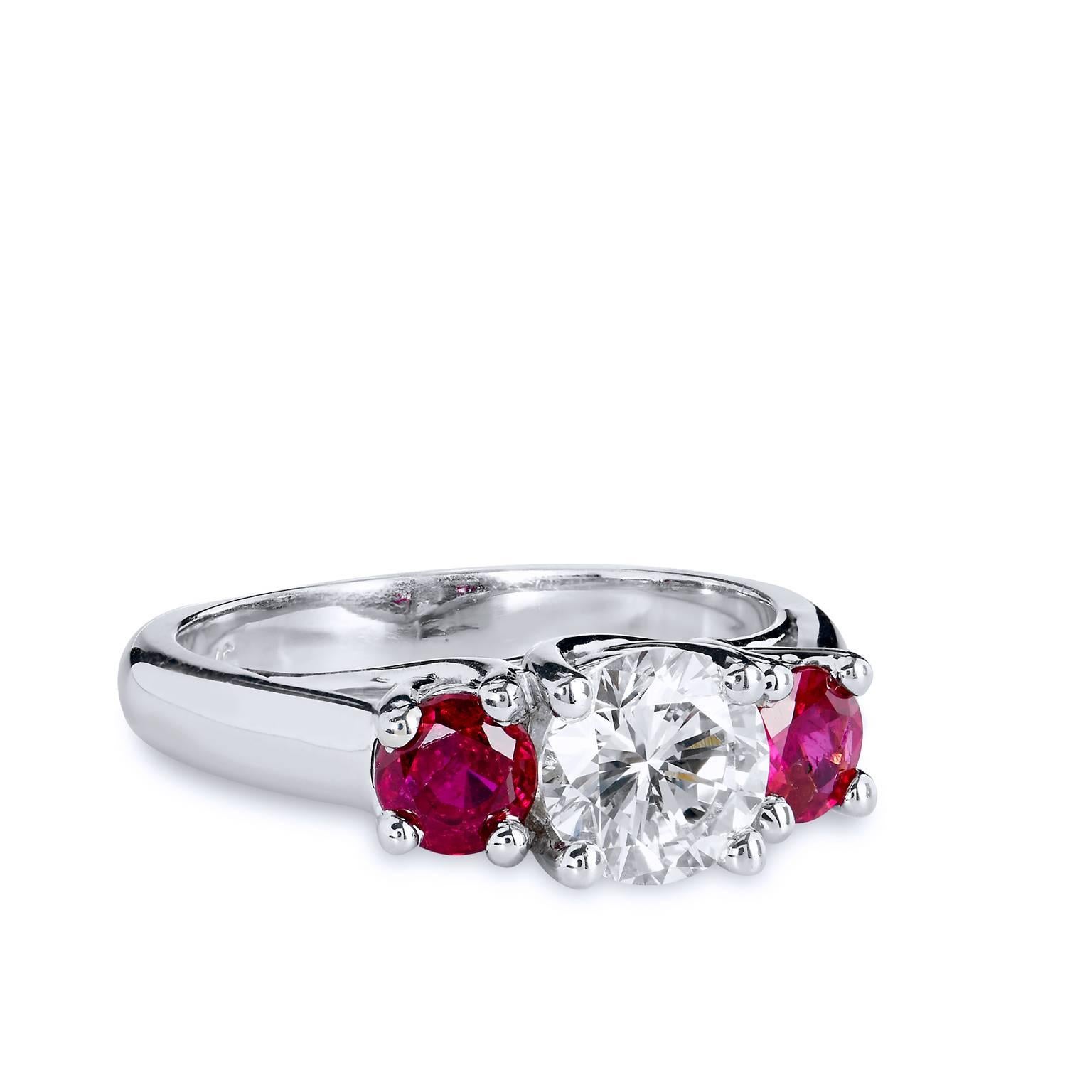 Handcrafted in 14kt white gold, this ring features two of the most desired gemstones-diamonds and rubies. A 1ct GIA certified center diamond graded L-VS1 shines bright amidst .80cts of Burma rubies set on either side. 