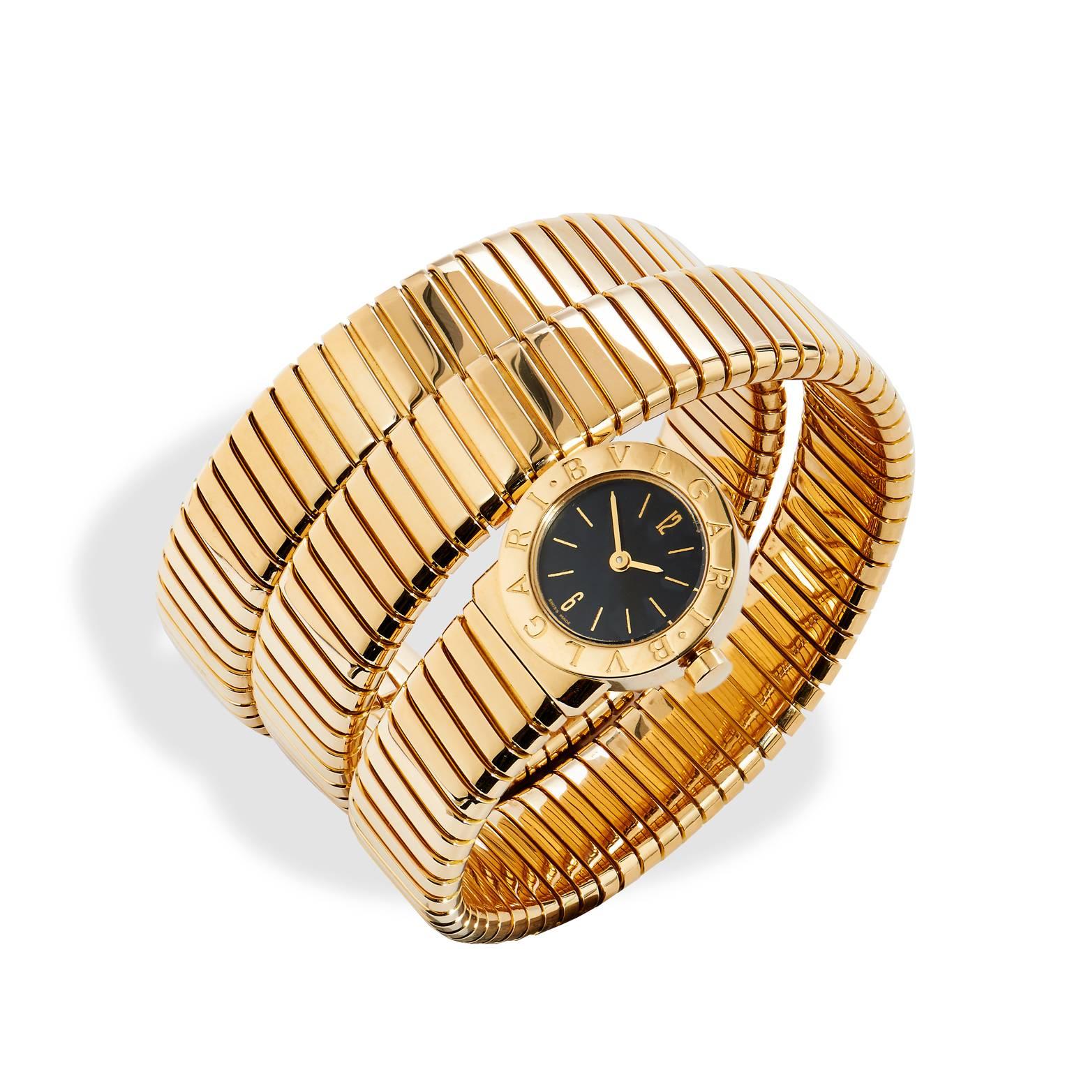 This Bvlgari Tubogas watch  is a cosmopolitan piece that mimics the sensual  movements of a snake with three 18kt yellow gold coils. This watch has a 19mm black dial and features Quartz movement. The piece is in mint condition and comes with box and