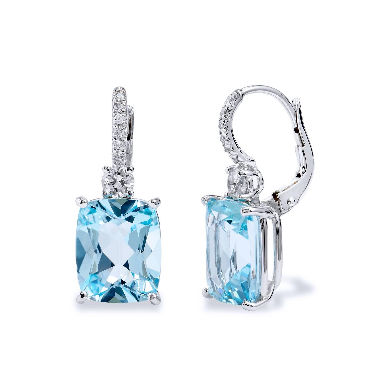 Awaking the senses to a scene in a winter snowfall, this pair of earrings features 10.25ct (11mmx9mm) of antique cut blue topaz that are suspended by .38ct of G/H SI1 diamonds mimicking the beauty of icicles. The color combination of the crisp blue