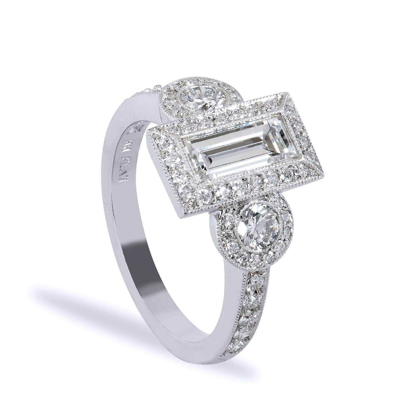 This ring showcases a truly feminine design that flawlessly marries structure with grace. Handcrafted in platinum, the ring features a 1.12ct GIA certified emerald cut diamond graded G-VS2 that displays clean symmetry in formation. The center