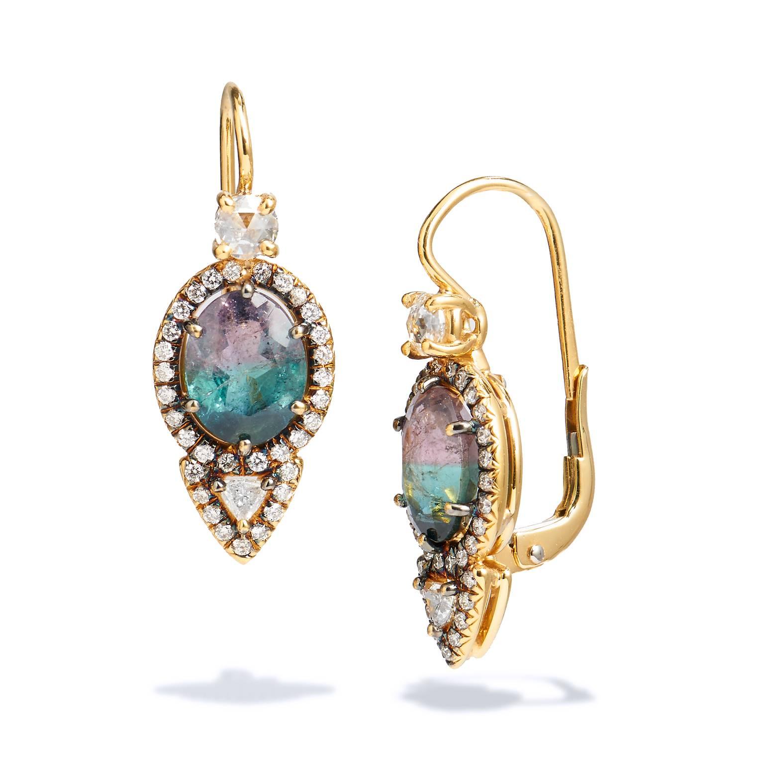 Handmade in 18kt yellow gold, this set up of earrings showcases two oval tourmalines with breathtaking color variation that fades from a divine purplish grey hue to a playful greenish turquoise.  0.14cts of trillion cut diamonds are suspended from