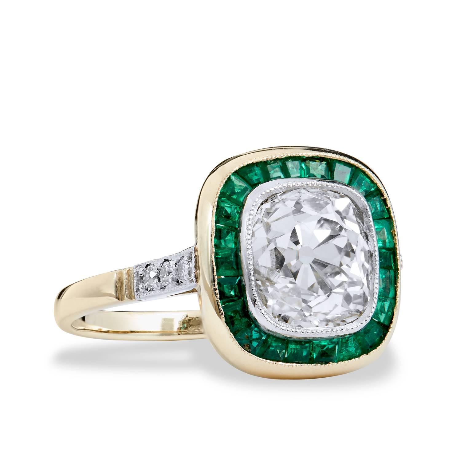 Suited for an engagement ring or a special occasion piece, this ring is a beautifully simple look with a special twist of design. The contrast of emeralds and diamonds creates a sensational color combination with an impressive 2.49ct O/P VS2 Old