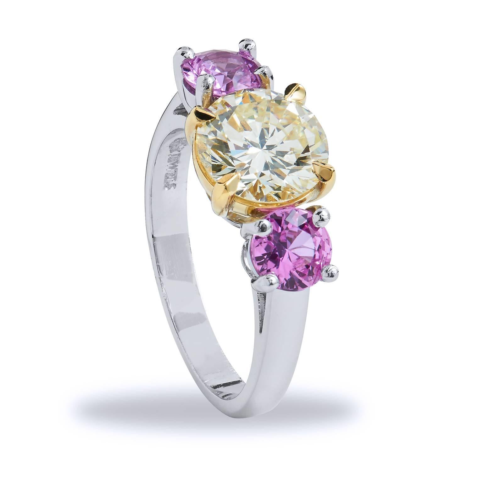 GIA Certified  1.81 Carat Three Stone Pink Sapphire Diamond Gold Platinum Ring 

Evoking the senses to the blossoming colors of spring with two radiant pink sapphires weighing 1.09 carat that hug a beautiful 1.81 carat GIA certified  round brilliant