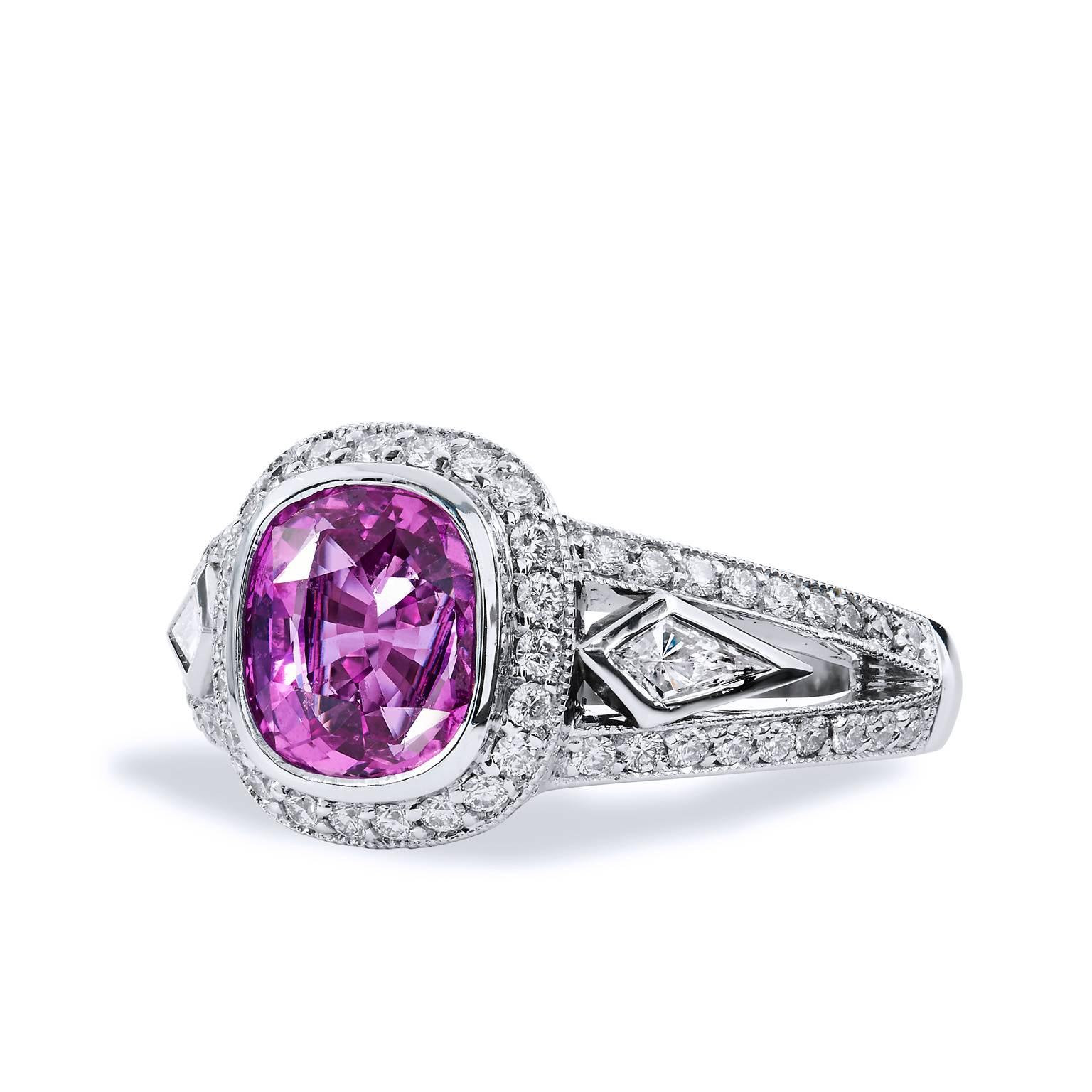 Crafted in 18kt white gold, this ring features a majestic 2.62ct pink sapphire with .48cts of F VS graded diamonds pave set around the center gemstone. Set in the shank are two kite shaped diamonds that flank either side of the pink sapphire