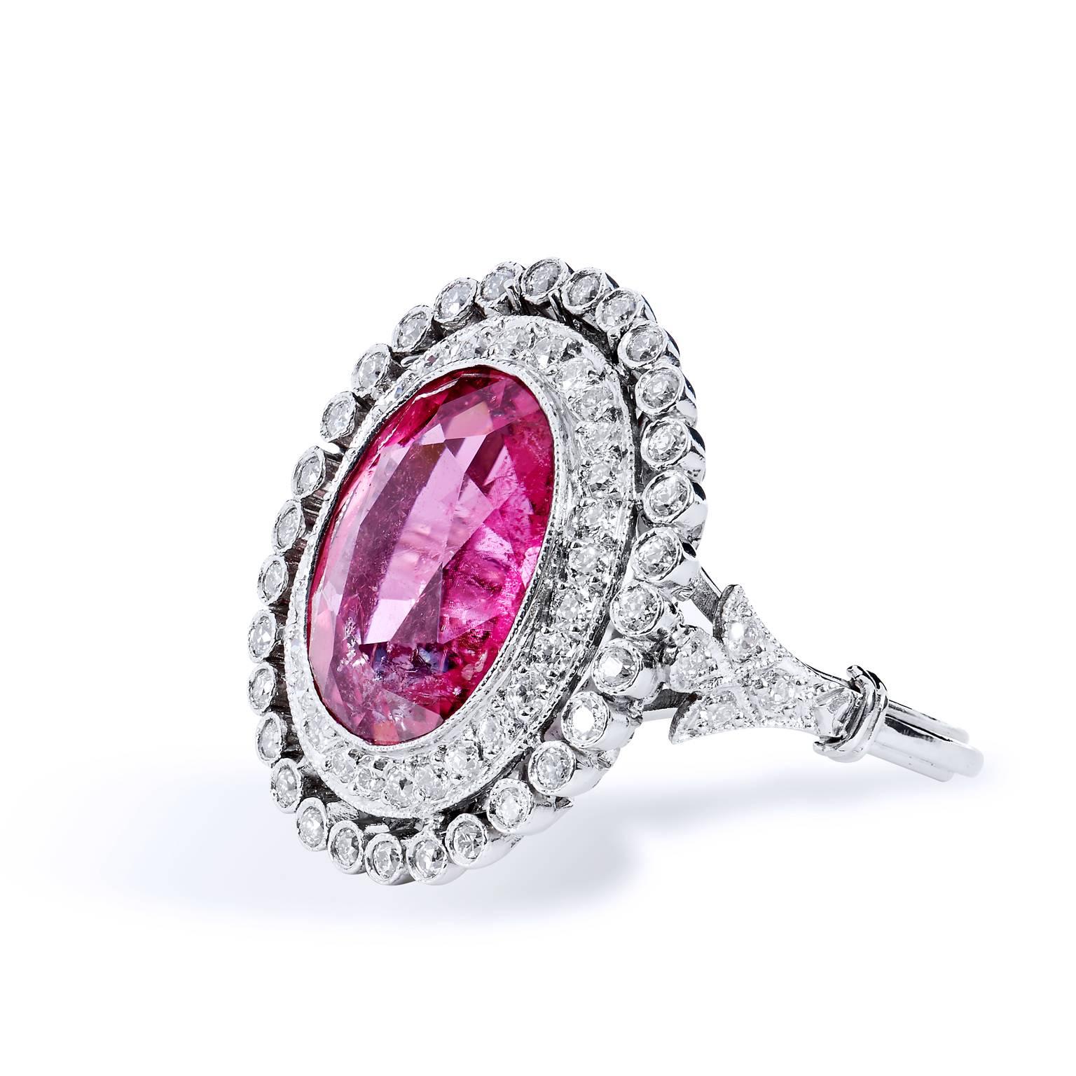 Art Deco Inspired 5.96 Carat Pink Tourmaline and Diamond Halo Platinum Ring

This is a stunning work of art.  Crafted in platinum, this Art Deco-inspired fashion ring features a 5.96 carat pink tourmaline embraced by two bands of Modern Old European