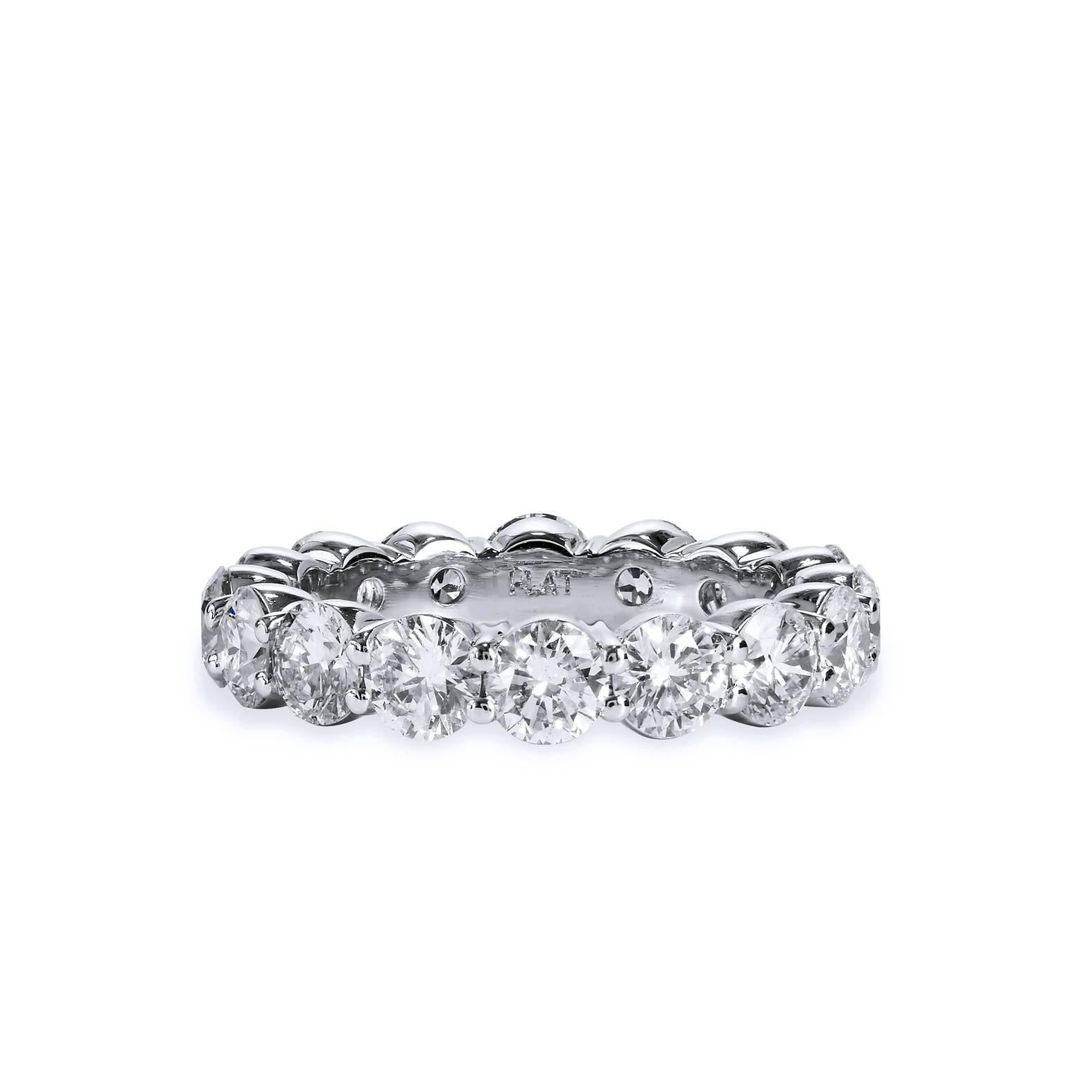 Crafted in platinum, this wedding band features 16 diamonds that wrap the finger and weighs approximately 3.98 total carats. The diamonds are graded I/J SI1 and are set with a shared prong design. The ring is a timeless anniversary band design that