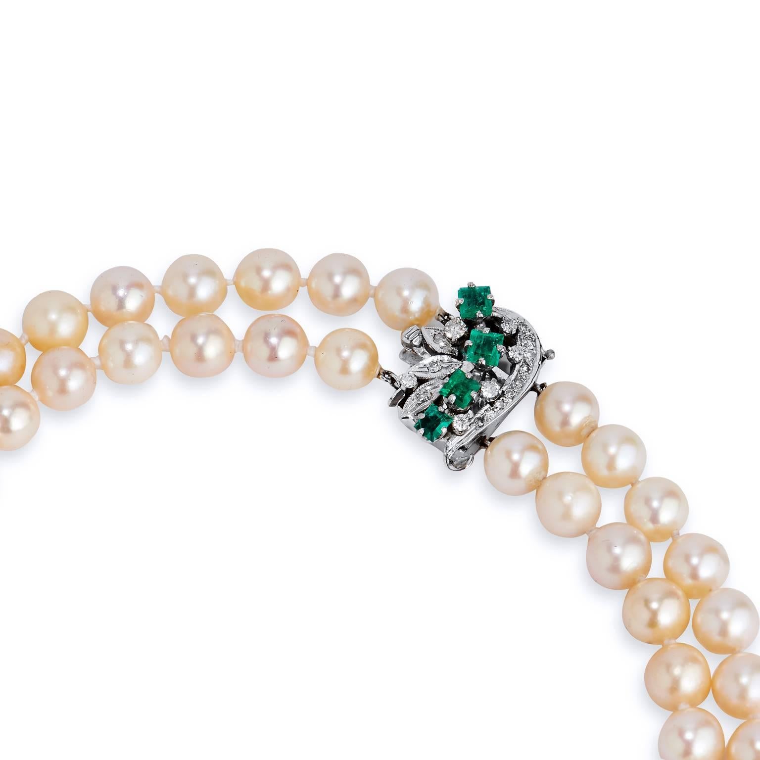 Crafted in 18kt white gold, this necklace is composed of Akoya Pearls measuring 7.5mm-8mm set in a beautiful double strand design. The clasp features approximately 1.50ct of Colombian Emeralds sprinkled with  approximately .25cts of single cut
