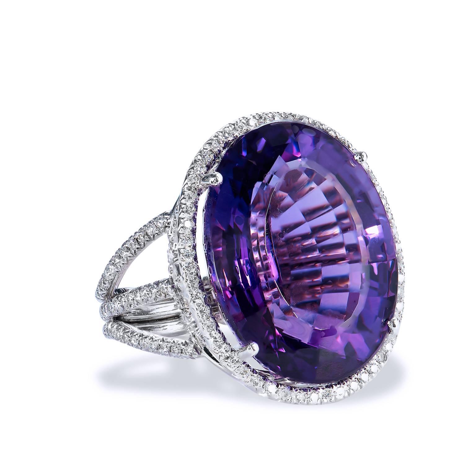 Handmade 22.70 Carat Amethyst and Diamond 18 karat White Gold Cocktail Ring

Crafted in 18kt white gold, this ring features a stunning 22.70ct Amethyst center gemstone. The Amethyst is showcased in a beautifully ornate setting that features .75ct of