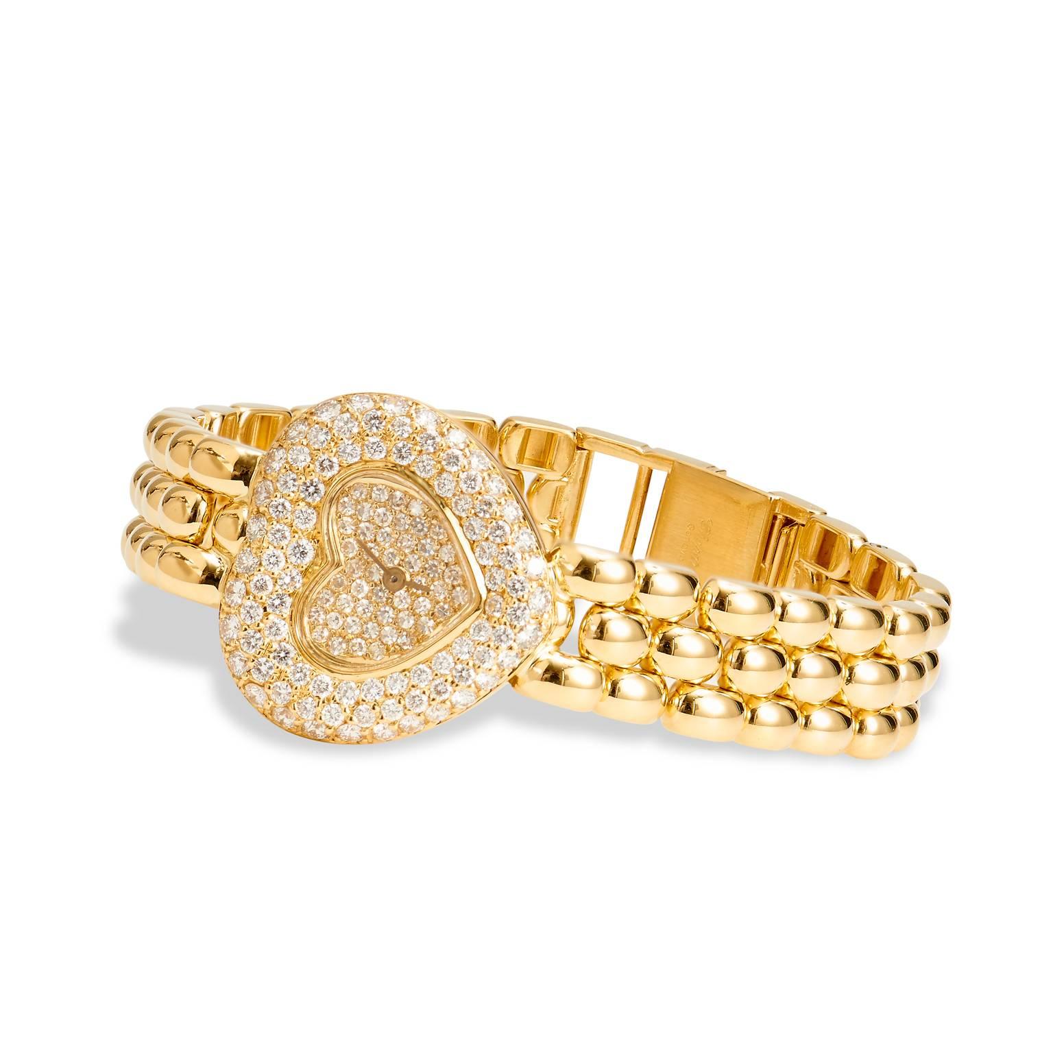 Crafted 18kt yellow gold, this classic Chopard ladies heart watch features 1.48ct of diamonds. Its serial #435600DO1 and Reference #105550-001. New list retail for this watch is $30,890. Our price is $15,595.