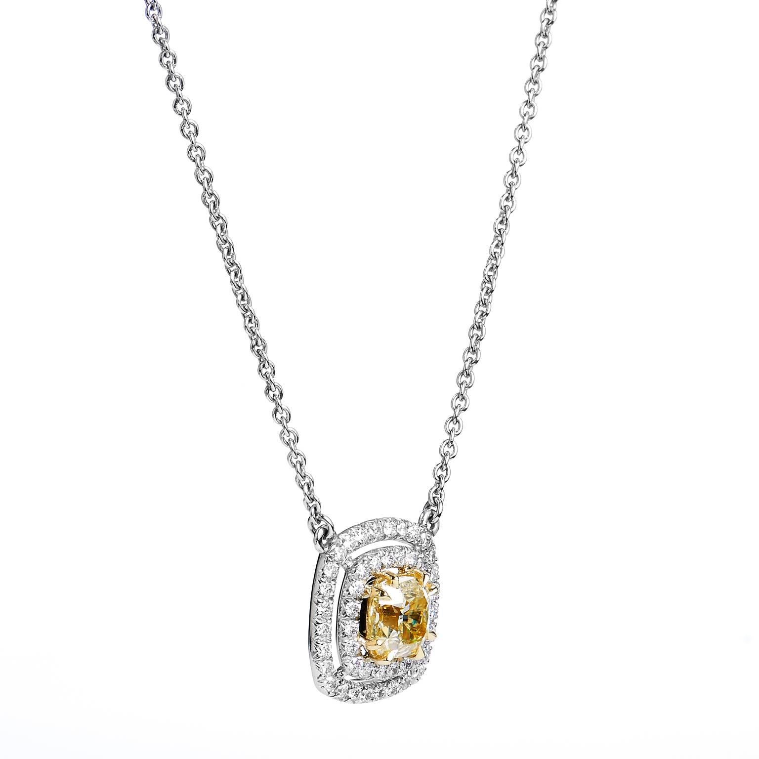 Handcrafted in platinum and 18kt yellow gold, this pendant showcases a 1.22ct fancy, brownish, greenish yellow diamond. This center diamond is GIA certified and graded VS2. Embracing the center diamond are 48 pieces of .42ct G/H VS pave diamonds.