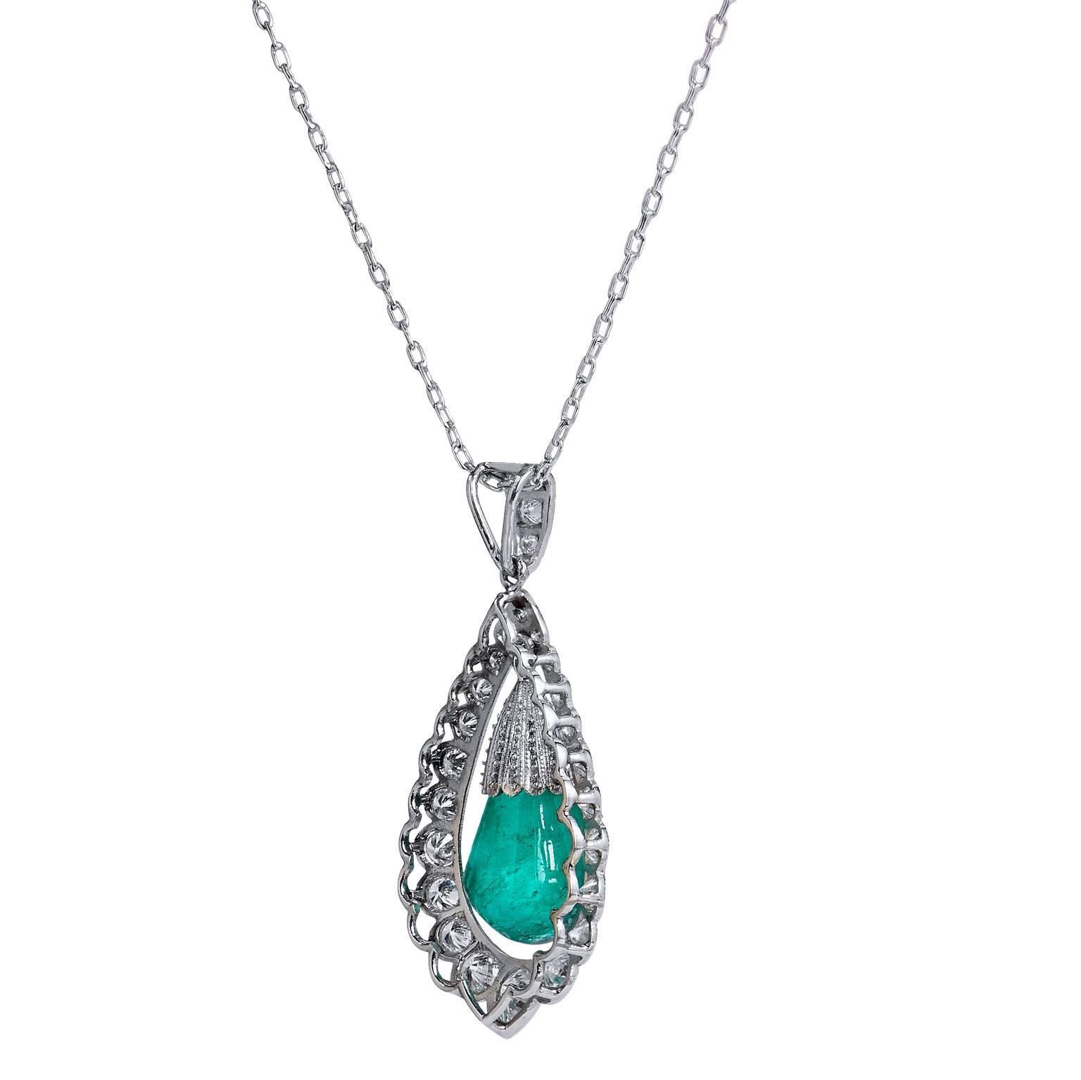 This pendant is crafted in platinum. It features 7.17ct cabochon drop emerald. The unique emerald is suspended and surrounding by 1.61 total carats of diamonds ranging in cuts from round brilliant, pear shape, rose and single cut. This Art Deco