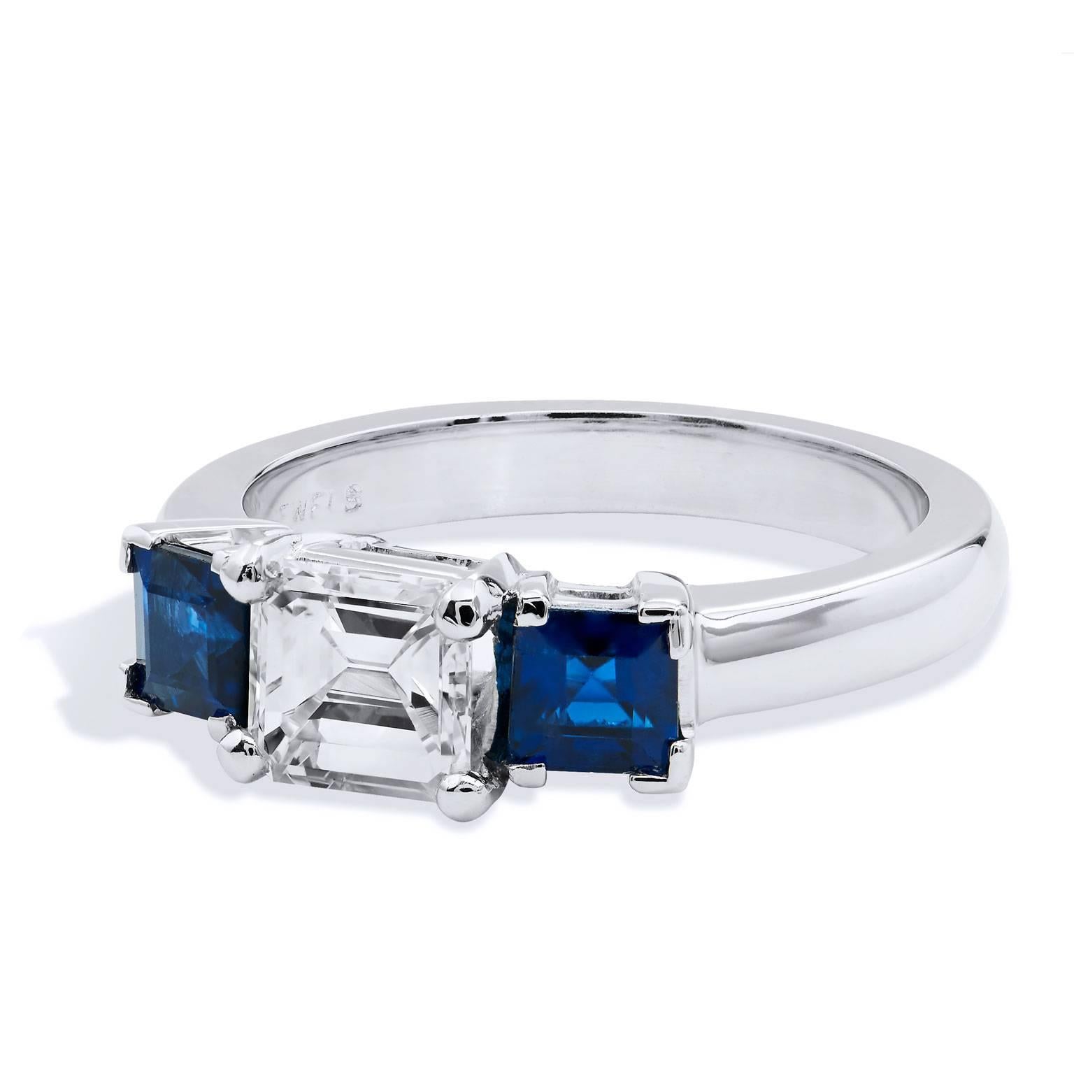 Handmade Three Stone Diamond and Sapphire 18 karat Gold Ring by H&H Jewels  

Refined and classic and minimal in design, this spectacular 18 karat white gold ring has a 0.80 carat emerald cut diamond affixed at center with two 0.90 carat total