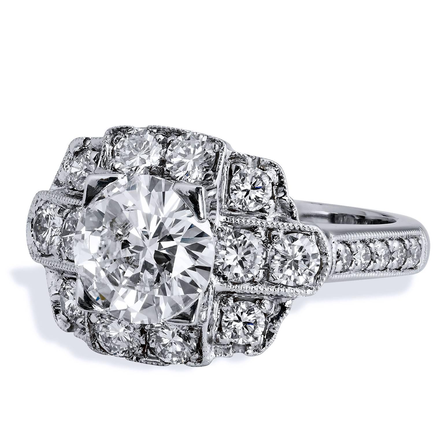 Make a timeless declaration of your love and commitment with this ornate platinum ring. A striking 1.60 carat diamond set at center stone (K/SI2; GIA # 2161131581) is encapsulated by twenty-two pieces of 0.93 carats of diamonds (J/K/VS) that bloom