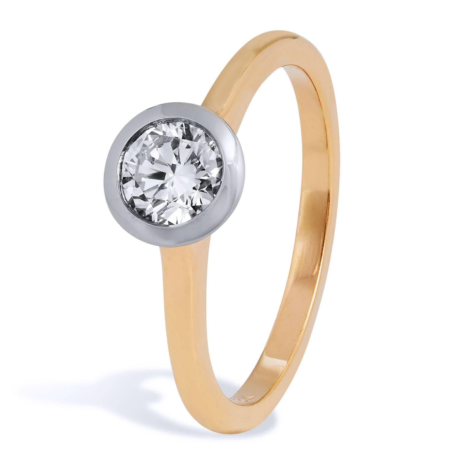 Enjoy the refined charm and grace of this 18 karat rose gold and white gold ring. A dazzling 0.59 carat round brilliant cut diamond (H/SI1; GIA #6157588930) in white gold bezel is set at center as a solitaire. While the warmth of the rose gold band