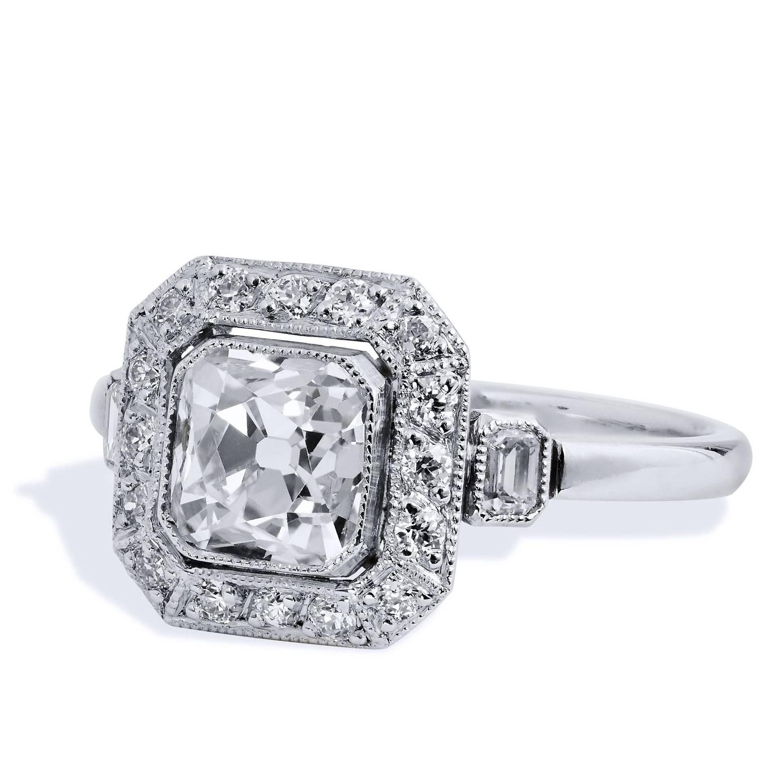 This platinum engagement ring features a rare 1.29 carat (N/VS2; GIA #2175226772) Peruzzi cut diamond at center. When compared to the modern round brilliant, the Peruzzi has a small table, a big crown and is much taller.Two pieces of emerald cut