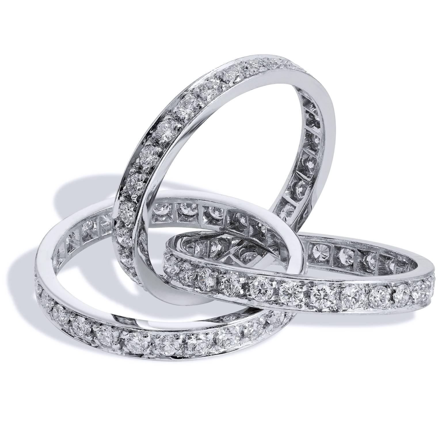 Pay tribute to the woman you love with this 18 karat white palladium and diamond triple roll ring. 2.90 carats of diamonds  (F/G/VS1), pave set, are suspended in a stunning three band arrangement. Each band falls gracefully and evokes the promise of
