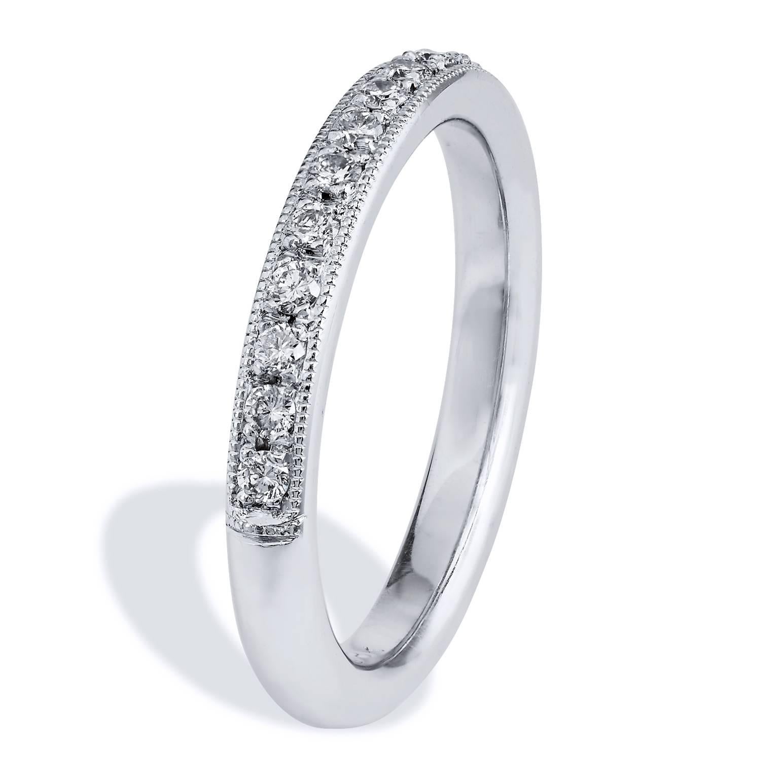 This band ring features 0.24 carat of round diamonds (G/H/SI1) pave set. Affixed to an 18 karat white gold band with milgrain work, this 2.50 mm thick ring provides a mosaic of light and color that twinkles with remarkable beauty.

