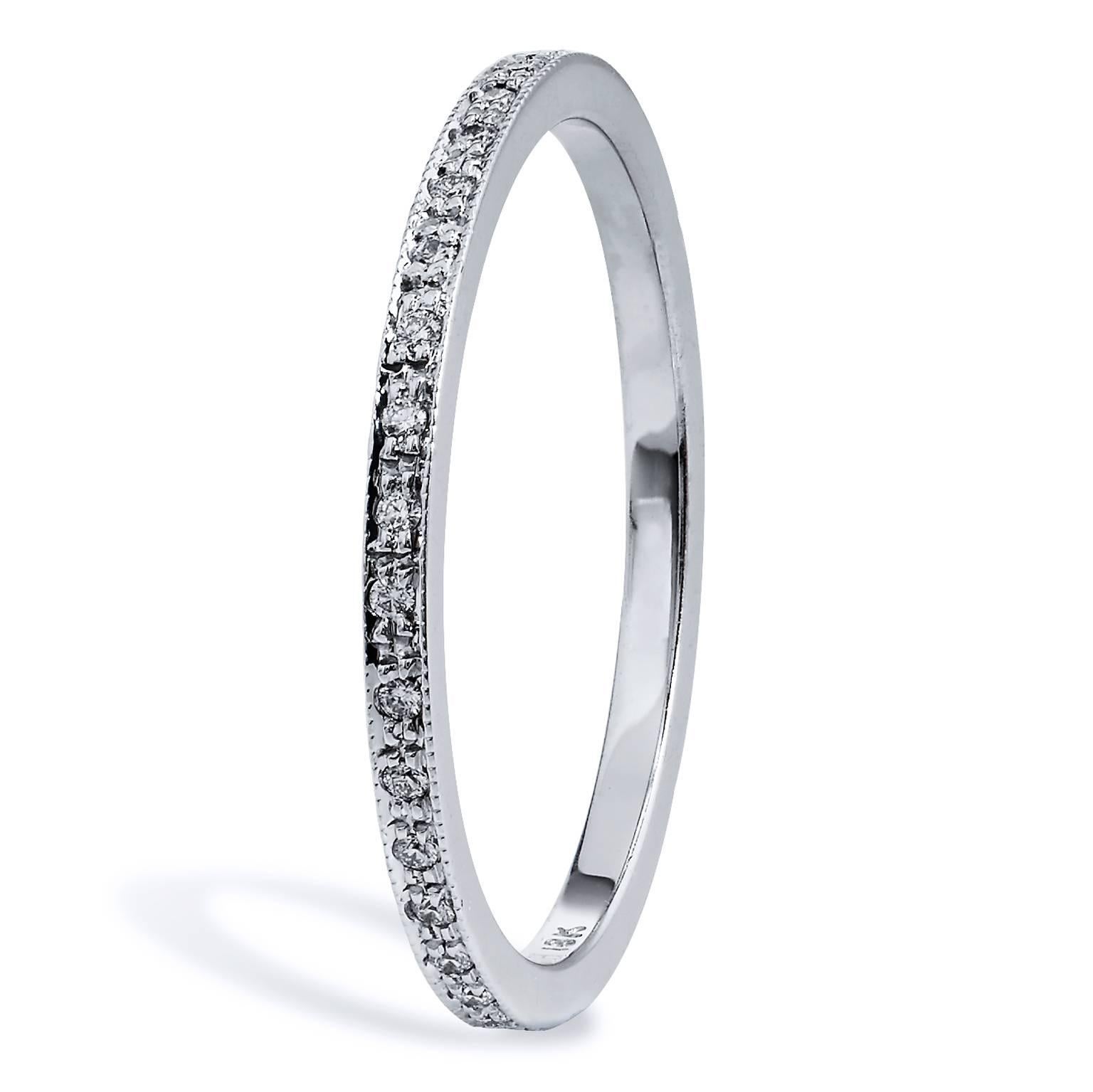 This band ring features 0.12 carat of Round cut diamonds (F/VS) pave set. Affixed to an 18 karat white gold band with milgrain work, this ring provides a mosaic of light and color that twinkles with remarkable beauty.