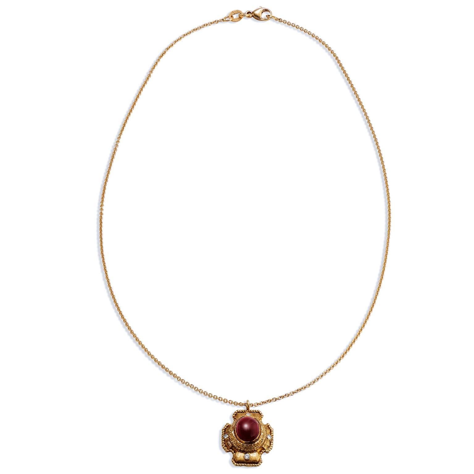 Stately in appearance, this handmade 18 karat yellow gold pendant on a pearl by the yard necklace features a striking rhodolite garnet at center with accompanying 0.12  carat of diamond to accent the varying hues of red.