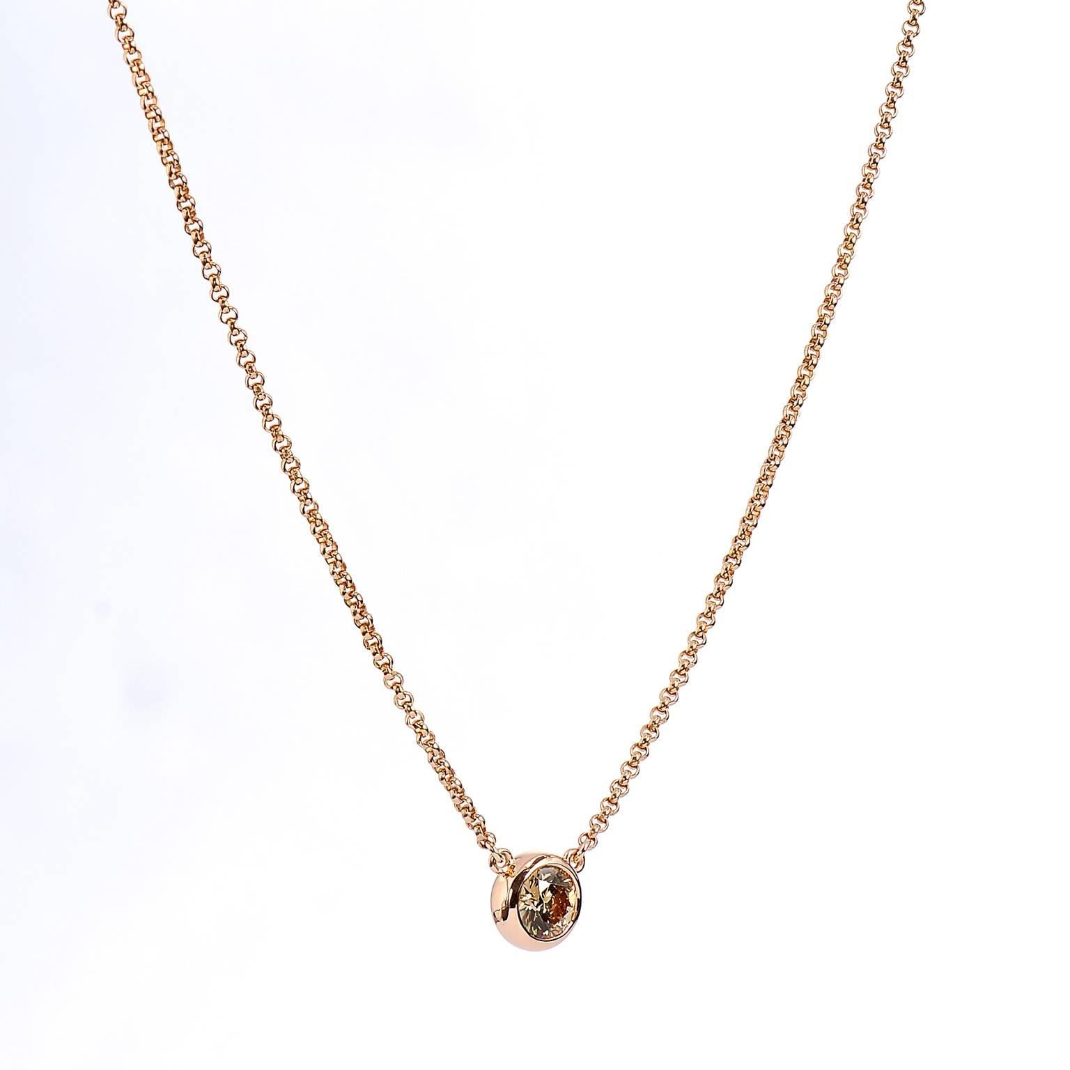 This H and H 18 karat rose gold pendant features a lovely brownish-yellow 0.72 carat diamond at center bezel set (VS1). Simplicity and refinement reign supreme in this piece. 