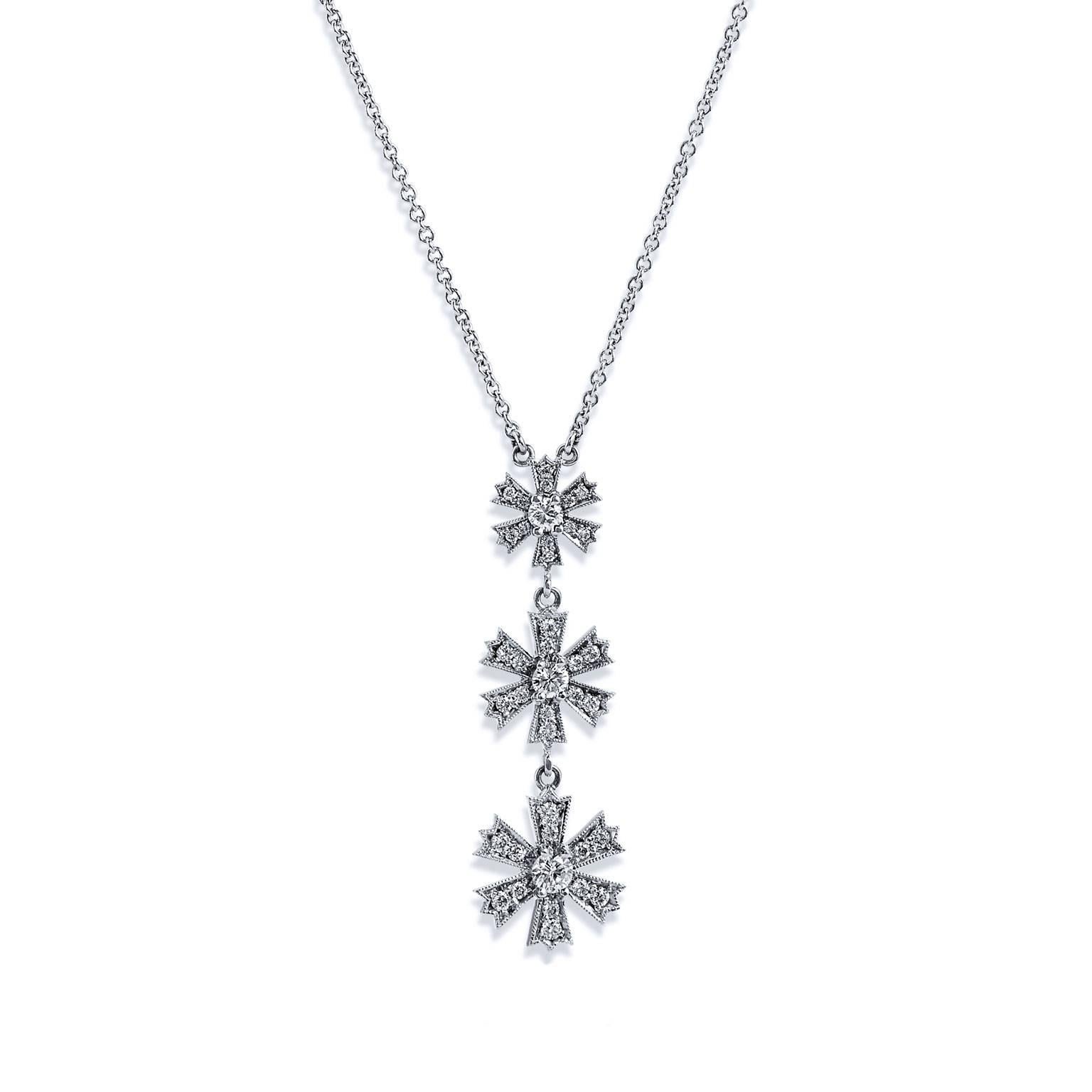 This H and H original necklace is hand-crafted in 18 karat white gold and features four flowers in varying sizes with a total weight of 0.90 carat in linear display (G/H/VS). Each flower reflects a round diamond in prong setting at center with