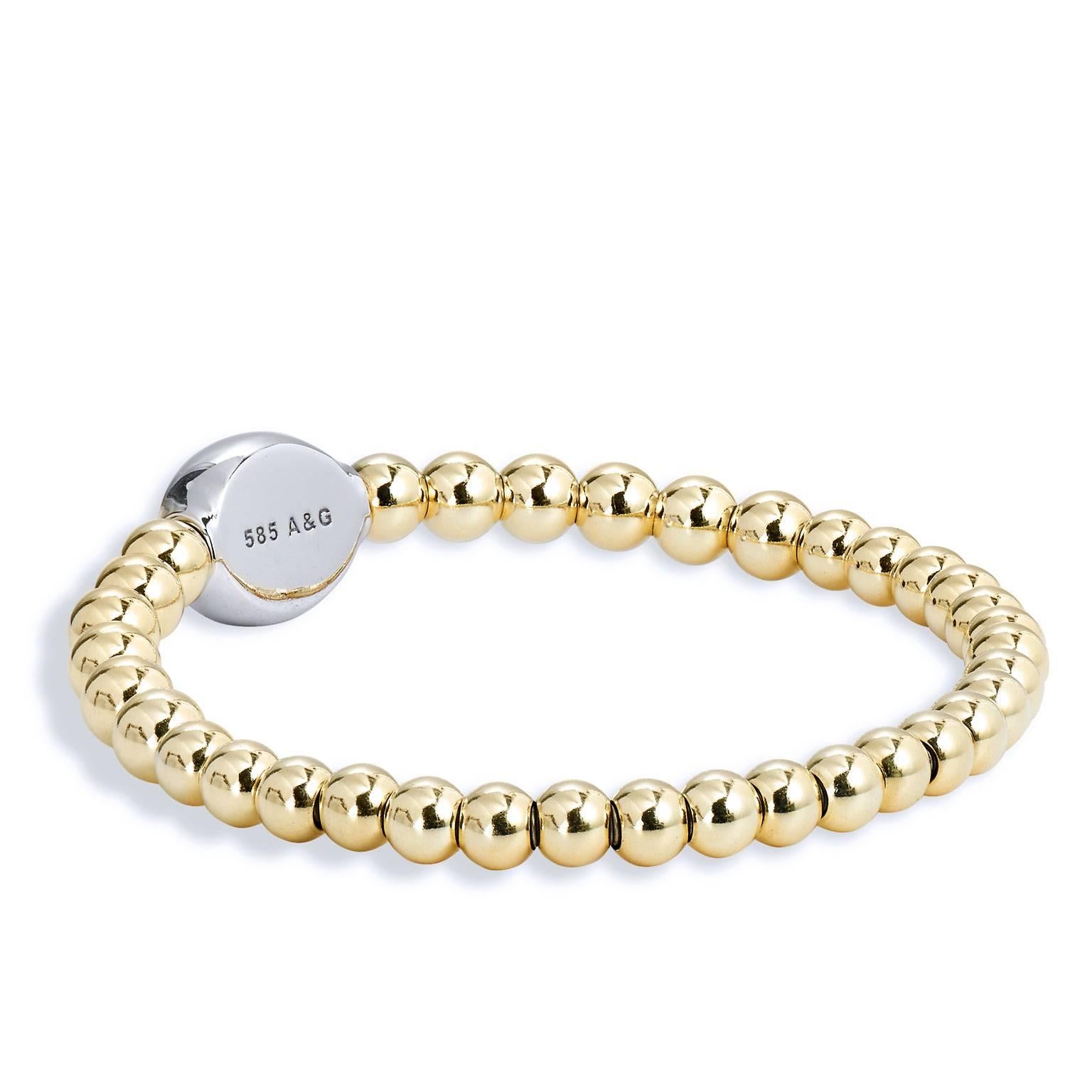 Bracelet with 14 karat yellow gold beads (5 mm to 5.5 mm bead size), white gold oval embellishment with 0.57 carat of diamond pave set and surgical steel insert.