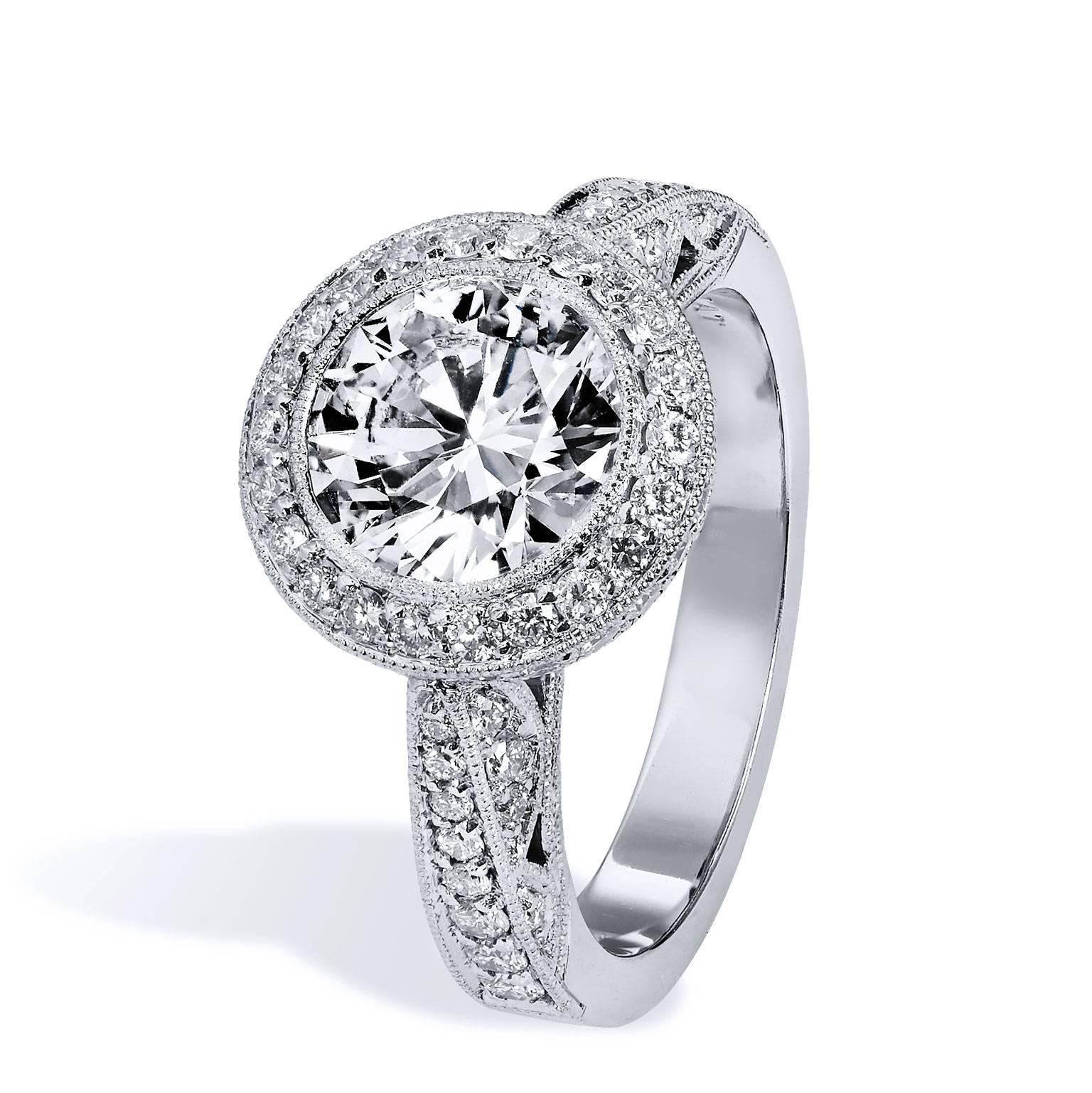 Own a piece of precious elegance with this stunning platinum engagement ring. Conjuring the appearance of lace, ornate milgrain work arranged in decorative webs with pave set diamonds, create a sense of lightness and luxury. Mystifying the beholder